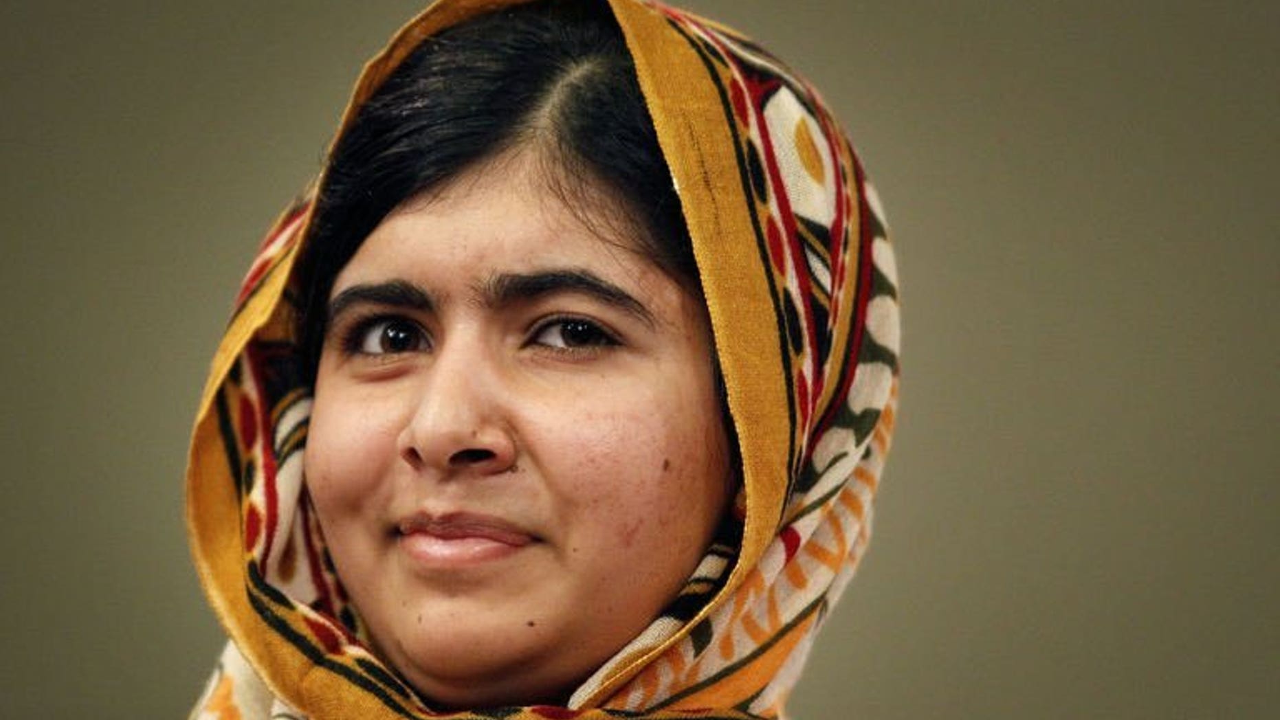 Pakistani activist Malala Yousafzai poses for a photograph after being awarded the International Children's Peace Prize at The Hague, on September 6, 2013.