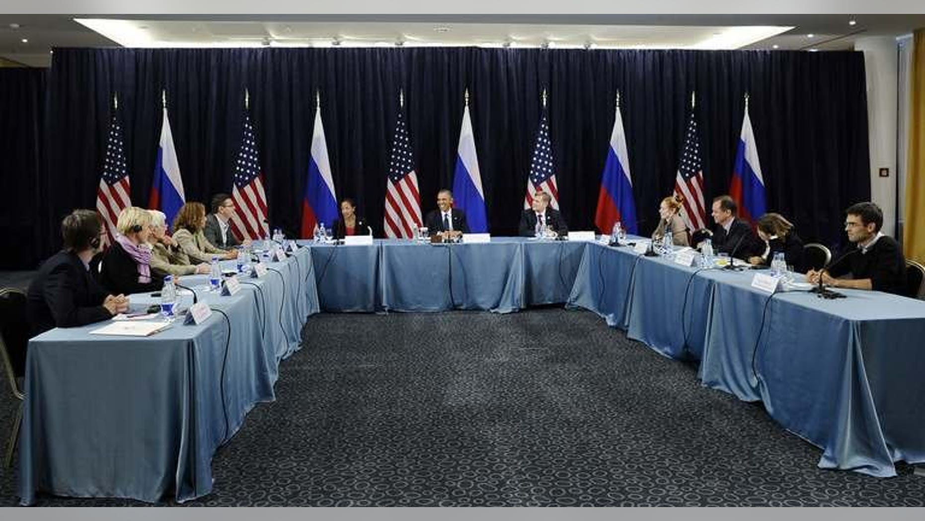 US President Barack Obama (C) holds a Civil Society Roundtable with gay, lesbian, transexual right activists at the Crowne Plaza Hotel in Saint Petersburg on September 6, 2013.