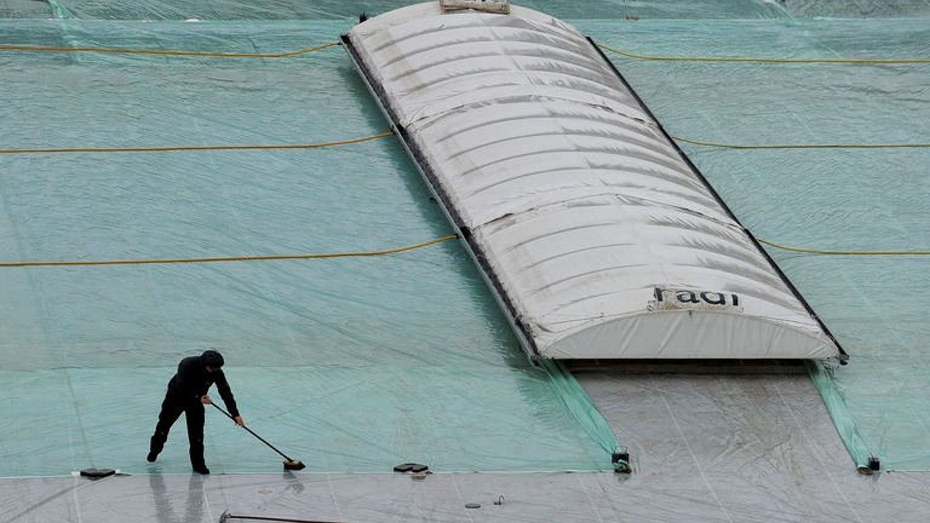 Staff work on the covers as rain delays the start of the first one day international match between England and Australia in Leeds, England, on September 6, 2013. Australia vice-captain George Bailey is praying the Manchester weather will not stop his side from giving England a tough time at Old Trafford.