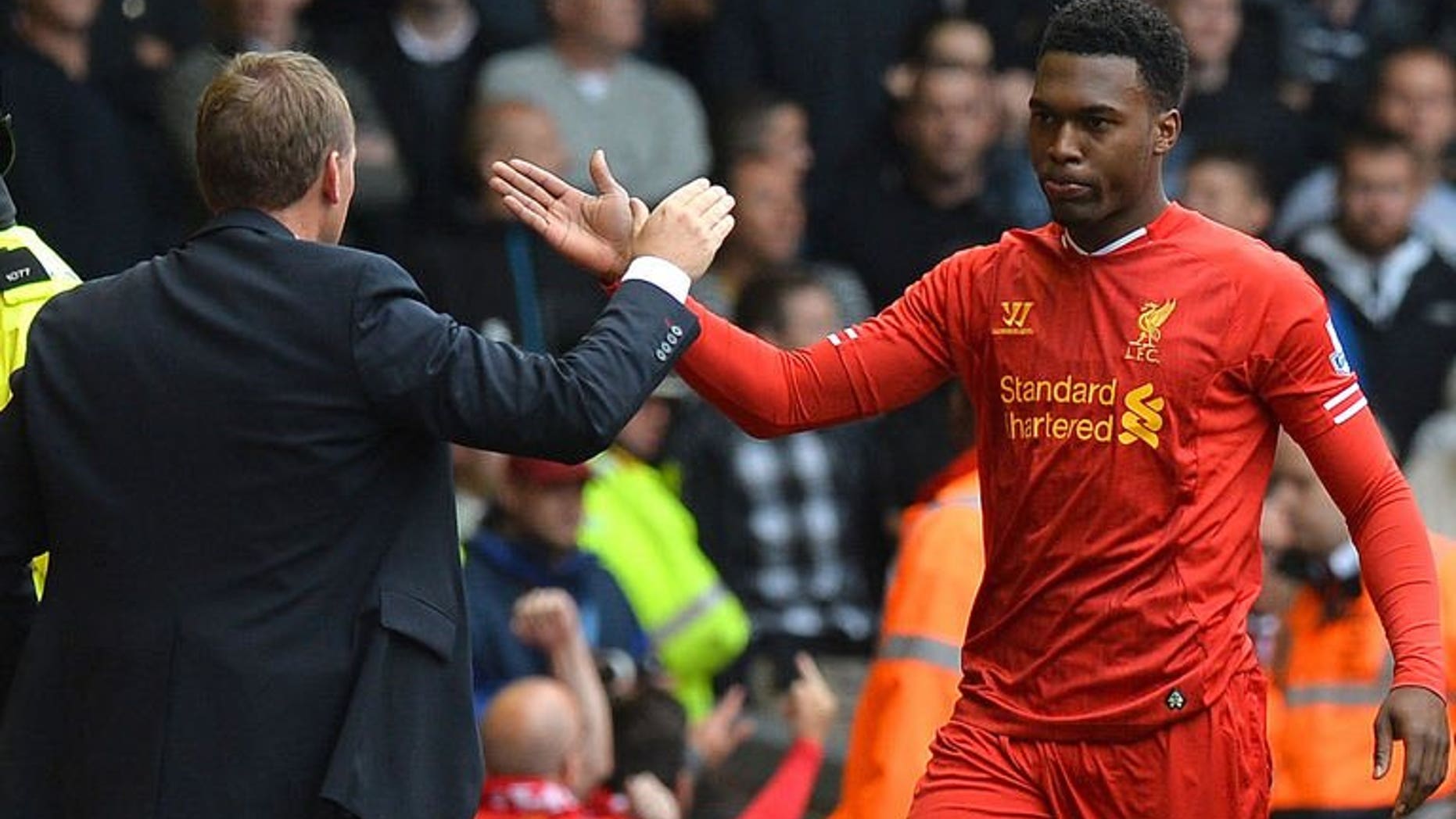 Liverpool's striker Daniel Sturridge (R) celebrates with Liverpool's manager Brendan Rodgers at the Anfield stadium in Liverpool, northwest England, on September 1, 2013. Sturridge has been ruled out of his side's crucial World Cup qualifier against Ukraine on Tuesday, the Football Association (FA) said Saturday.