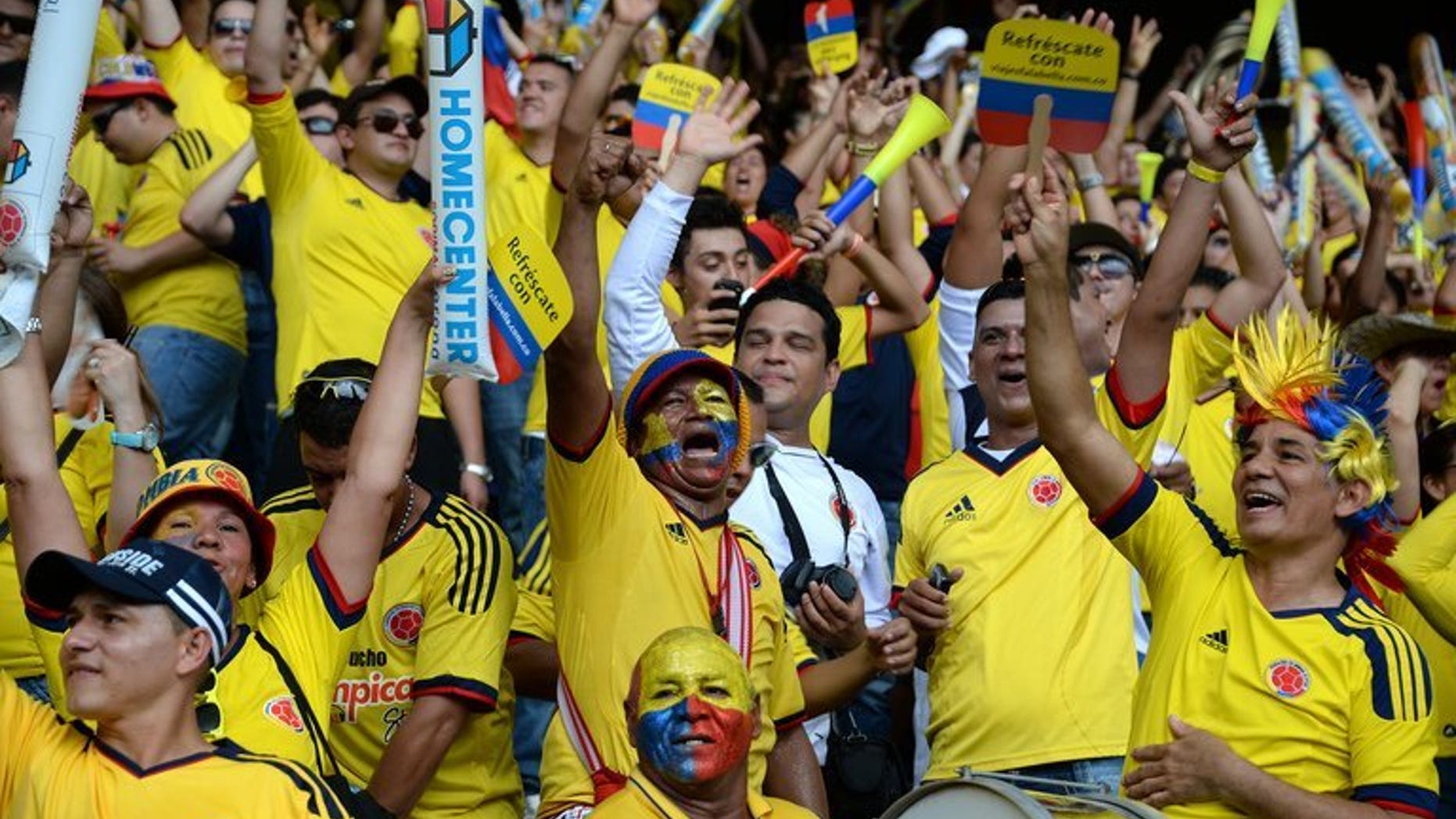 Colombian supporters cheer for their team before the start of the FIFA World Cup Brazil 2014 qualifying match against Ecuador at the in Barranquilla on September 6, 2013. An alleged drug don, Claudio Baez, was arrested in Colombia as he headed to the football match, police said Saturday.