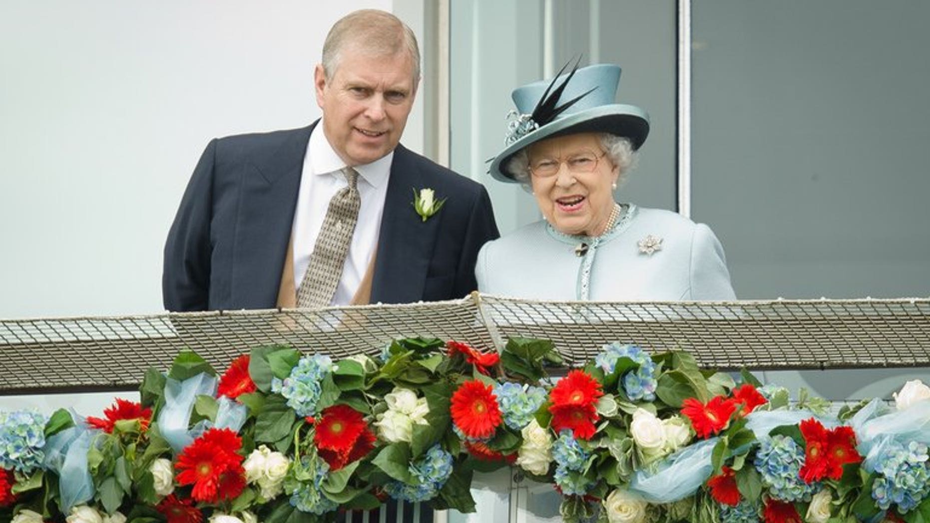 Prince Andrew, the Duke of York, speaks to Queen Elizabeth II at the Epsom Derby Festival in England on June 1, 2013. Prince Andrew was challenged by jittery royal protection officers in the gardens of Buckingham Palace last week as they stepped up security following a break-in, police admitted on Sunday.