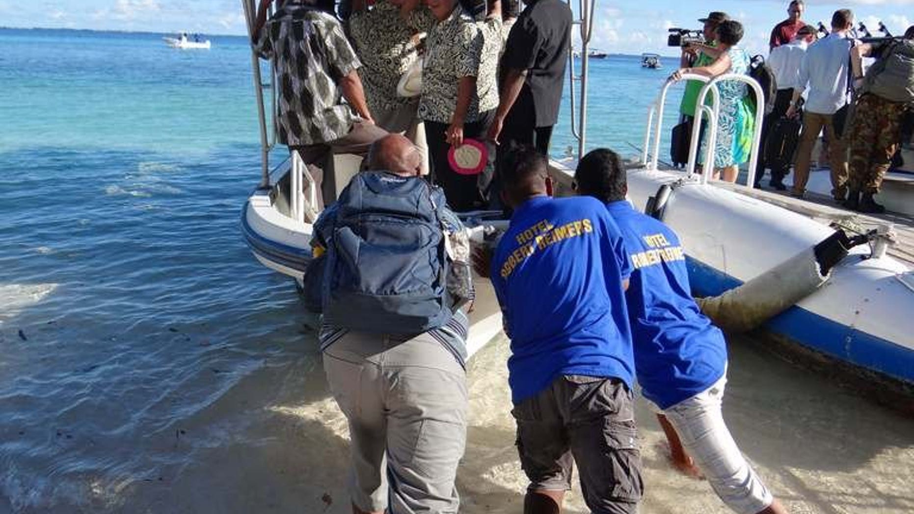Staff push a boat used to transport Pacific Islands Forum leaders from Eneko Island on September 5, 2013. A new Pacific regional pact calling for aggressive action to combat climate change has achieved a "major accomplishment" by gaining US support, officials said Sunday.