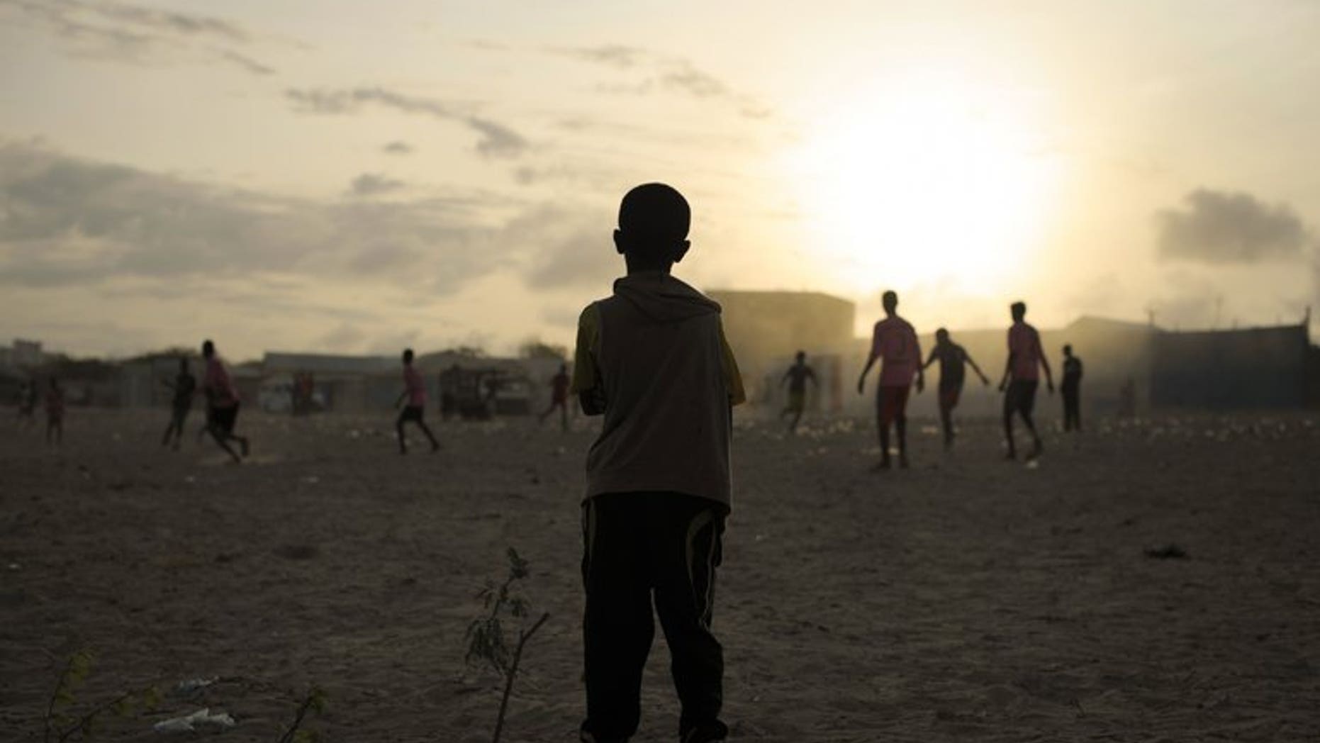 Children play football near a camp for Internally Displaced Persons in Mogadishu, Somalia on August 19, 2013. The Somali authorities are launching Sunday a campaign aimed at getting one million children in the war-torn nation into school, the United Nations' children's agency said.