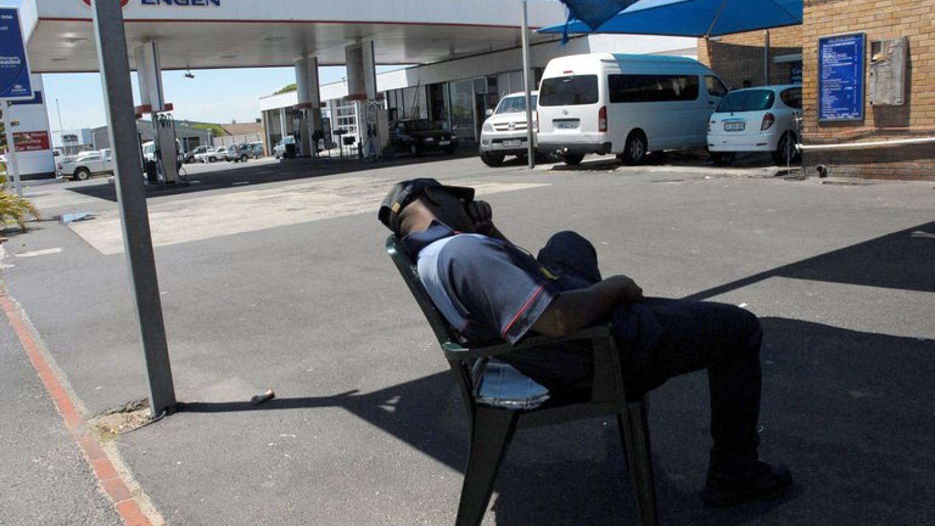 A petrol attendant takes a break in Cape Town. Tens of thousands of South African petrol attendants and car repair workers will strike for higher wages and better conditions, their union said, as stoppages in other sectors wound down.