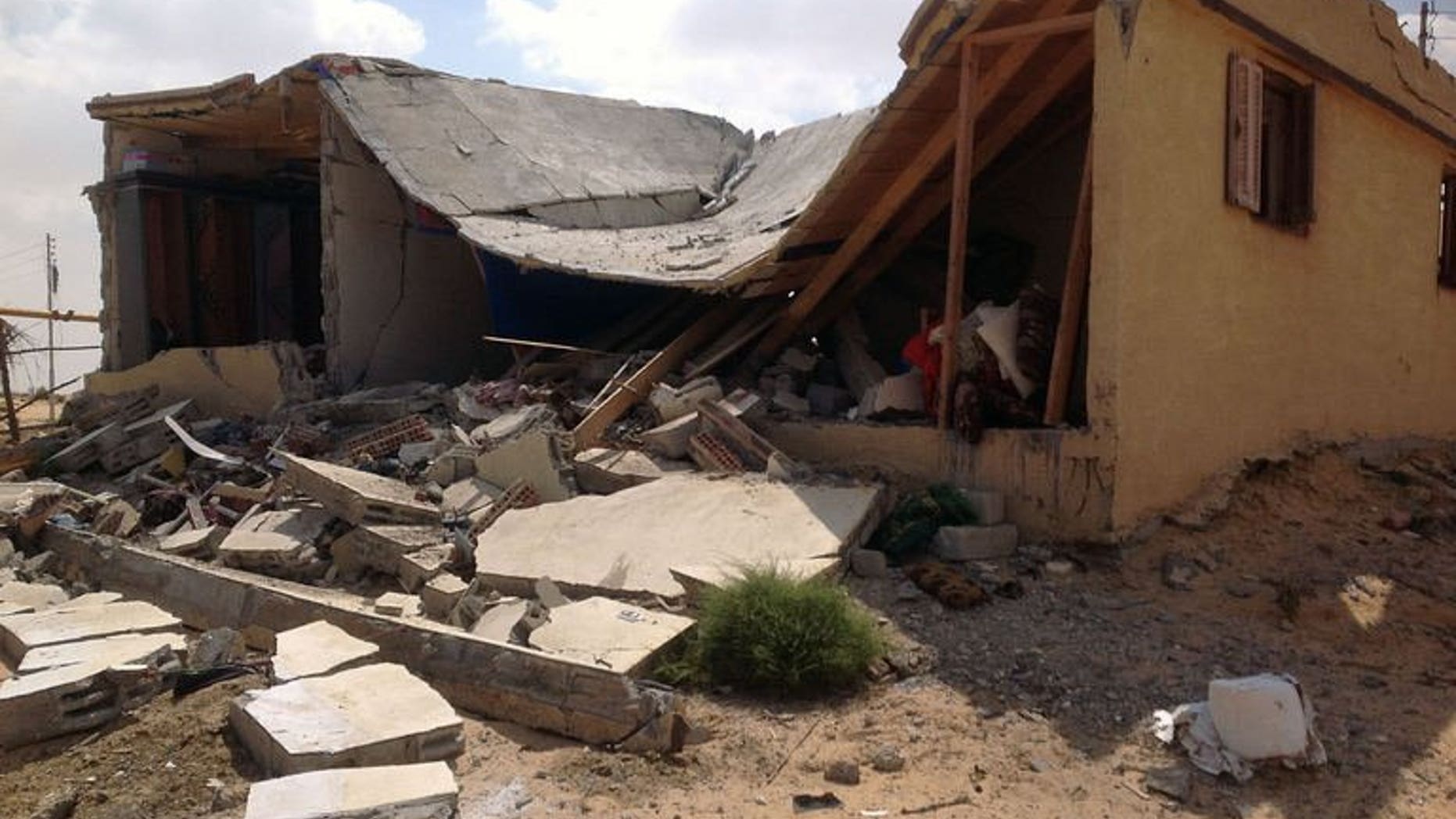 Damaged buildings are seen on September 3, 2013 in al-Toma village on the outskirts of Egypt's northern Sinai town of Sheikh Zuweid. after it was hit during an army operation. Egyptian military helicopters carried out a second day of air raids in the Sinai Peninsula, where they are facing an insurgency by Islamist militants, witnesses said.