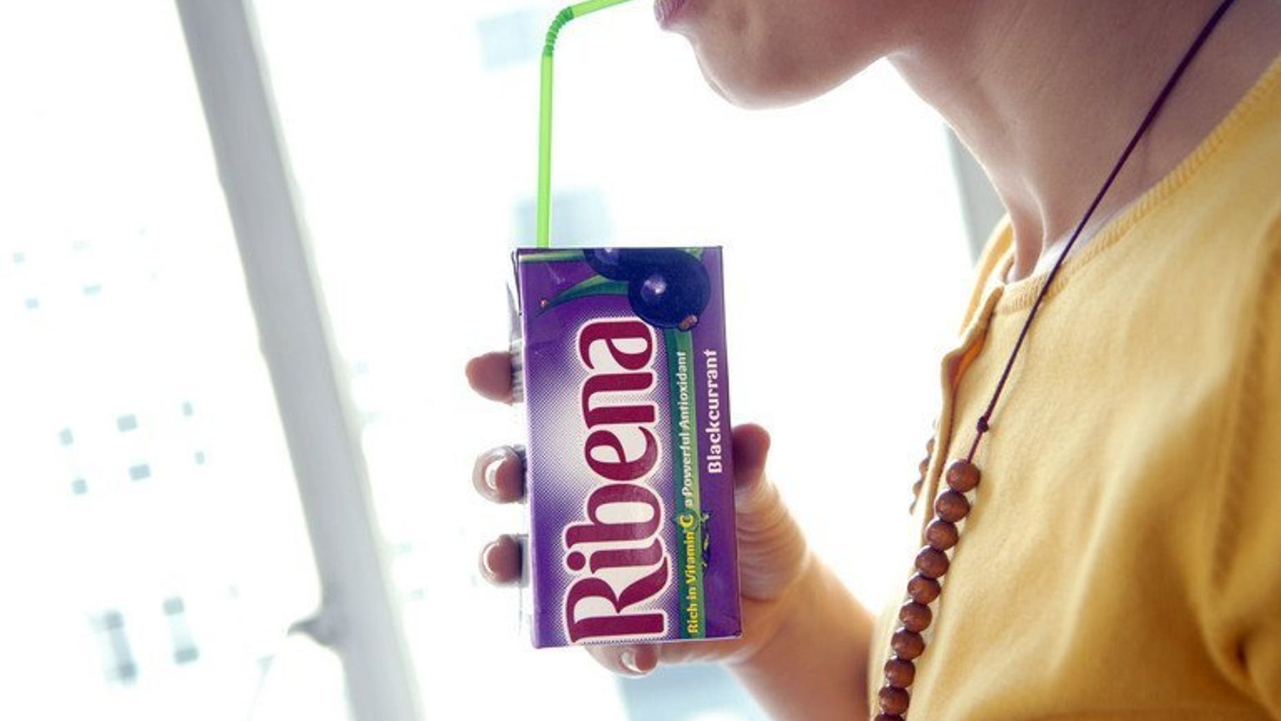 A woman sips a Ribena drink in London, March 28, 2007. Japanese drinks giant Suntory Holdings is to buy the Lucozade and Ribena brands from British drugs firm GlaxoSmithKline for $2.1 billion.