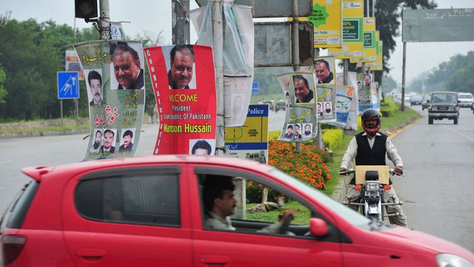 Roadside banners welcoming and congratulating incoming Pakistani President Mamnoon Hussain are pictured in Islamabad on September 9, 2013.