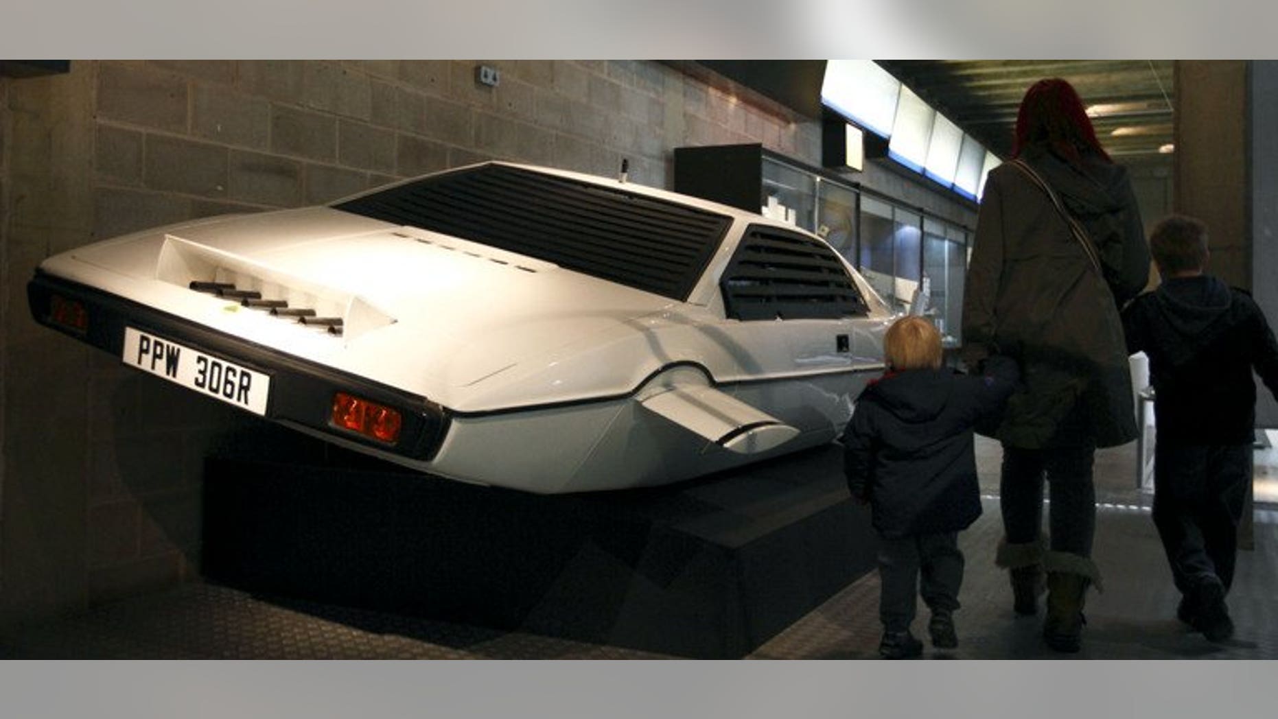 A family walks past the Lotus Esprit underwater car from the James Bond film "The Spy Who Loved Me" at the Beaulieu National Motor Museum on January 15, 2012.