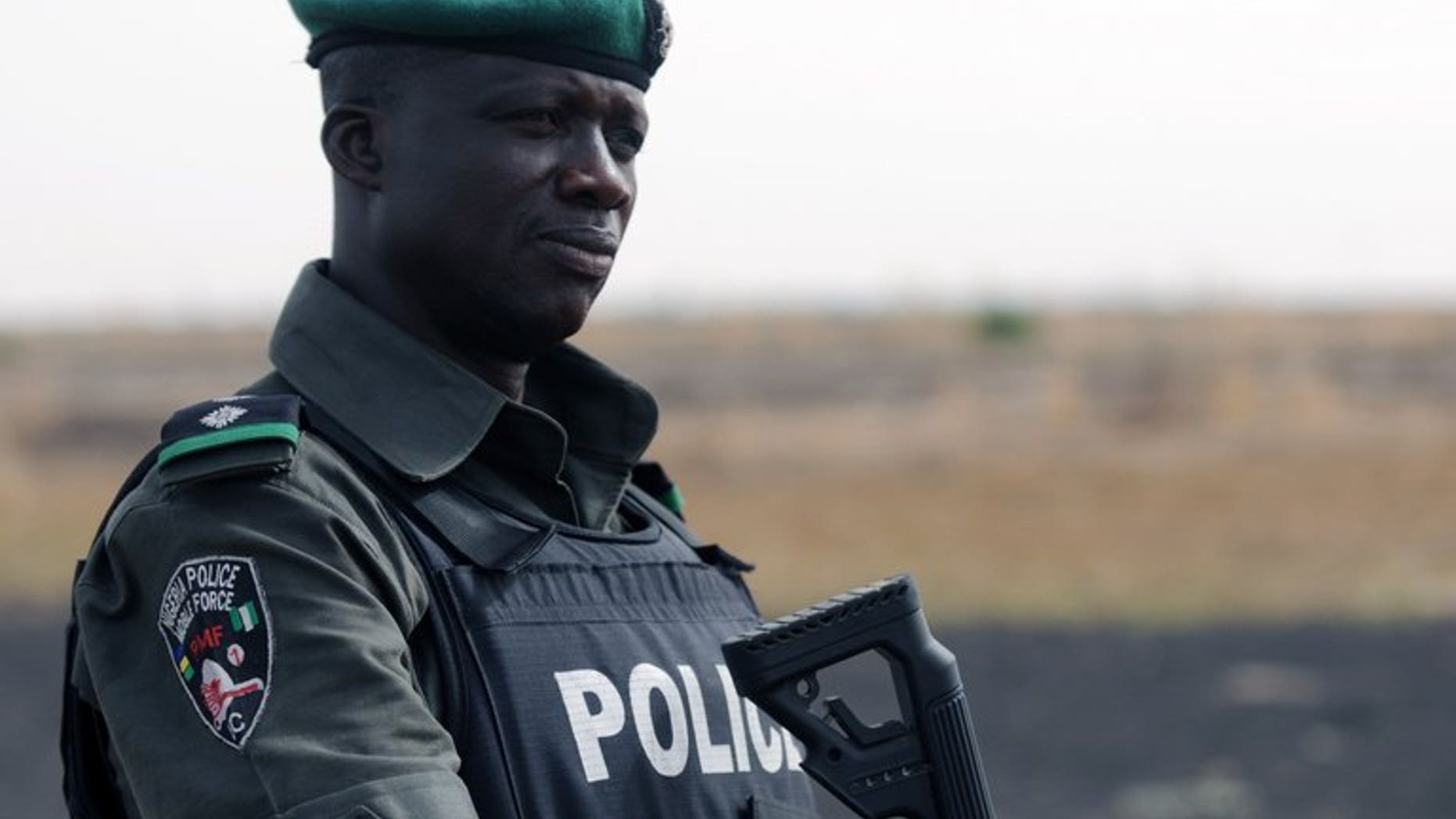 A Nigerian policeman patrols with Nigerian soldiers in the north of Borno state on June 5, 2013 near Maiduguri.
