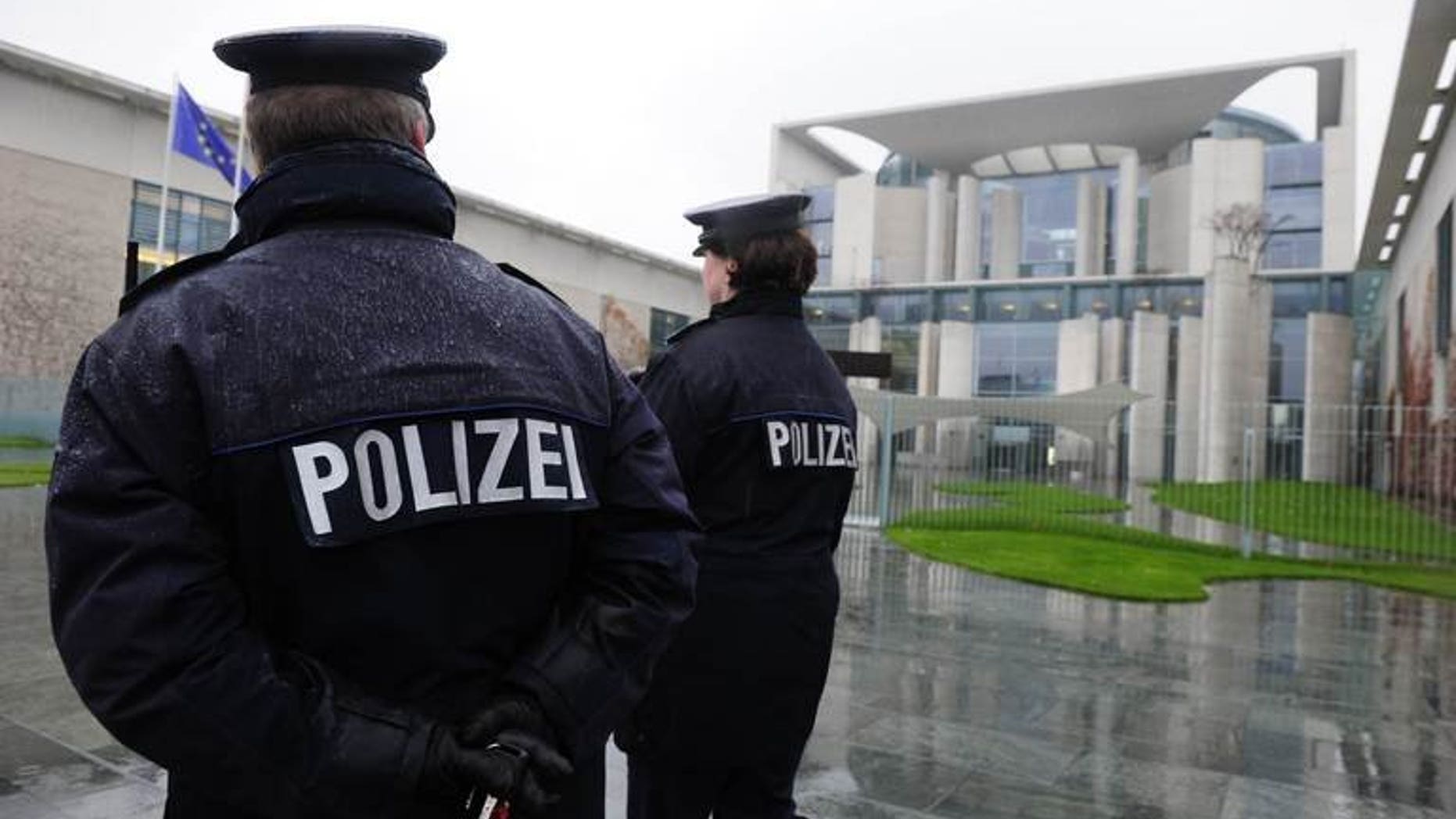 German police officers patrol in front of the Chancellery in Berlin on November 18, 2010. German police have arrested a man over an alleged far-right plot to use explosives mounted on a model airplane against political opponents, authorities said Tuesday.