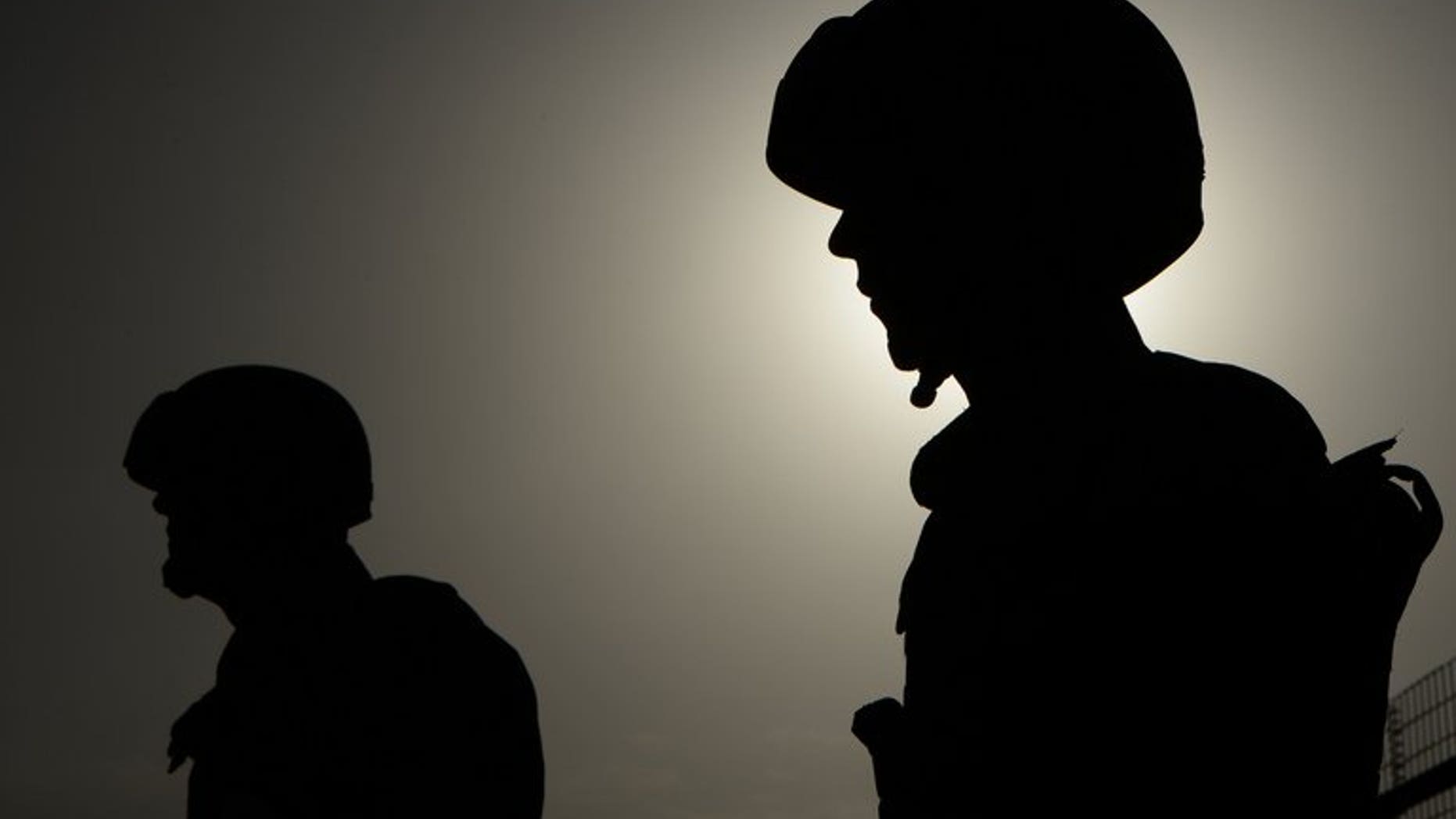 Two Afghan policemen stand guard in Kabul on August 20, 2013. Afghan police have arrested two militants over the murder of an Indian writer whose book about her dramatic escape from the Taliban was made into a Bollywood film, an official said Tuesday.