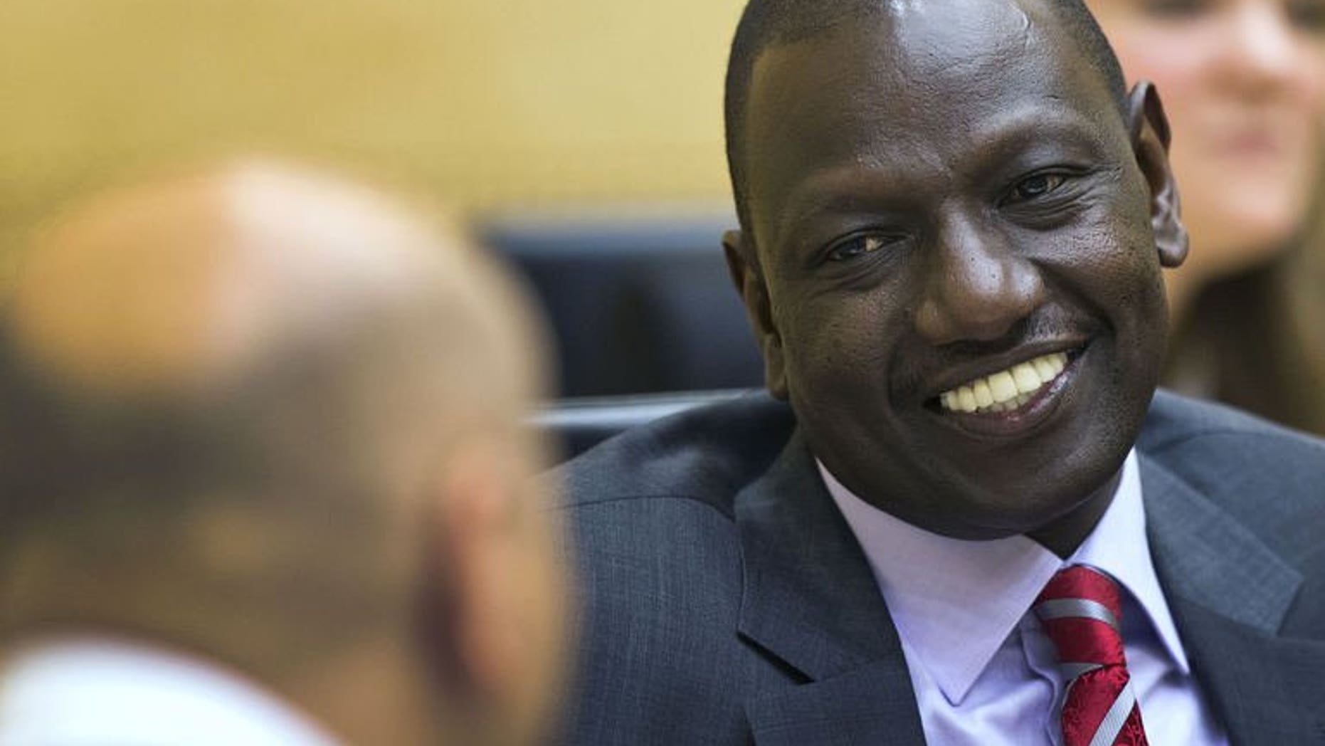 Kenya's Vice President William Ruto (right) speaks with his lawyer before the start of his trial at the International Criminal Court in The Hague, on September 10, 2013.