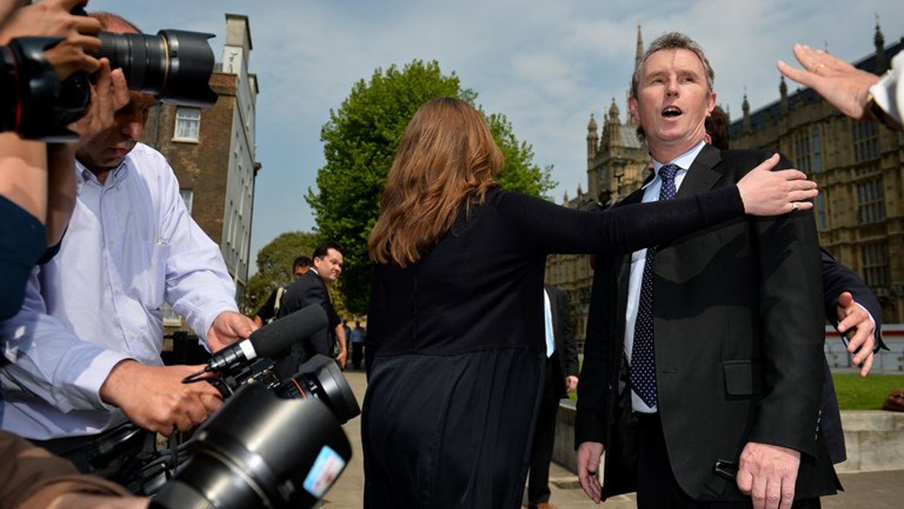 Journalists question deputy speaker Nigel Evans (R) outside London's Houses of Parliament, on May 7, 2013. Evans has been re-arrested on suspicion of indecent assault and sexually touching two further alleged victims, police said.