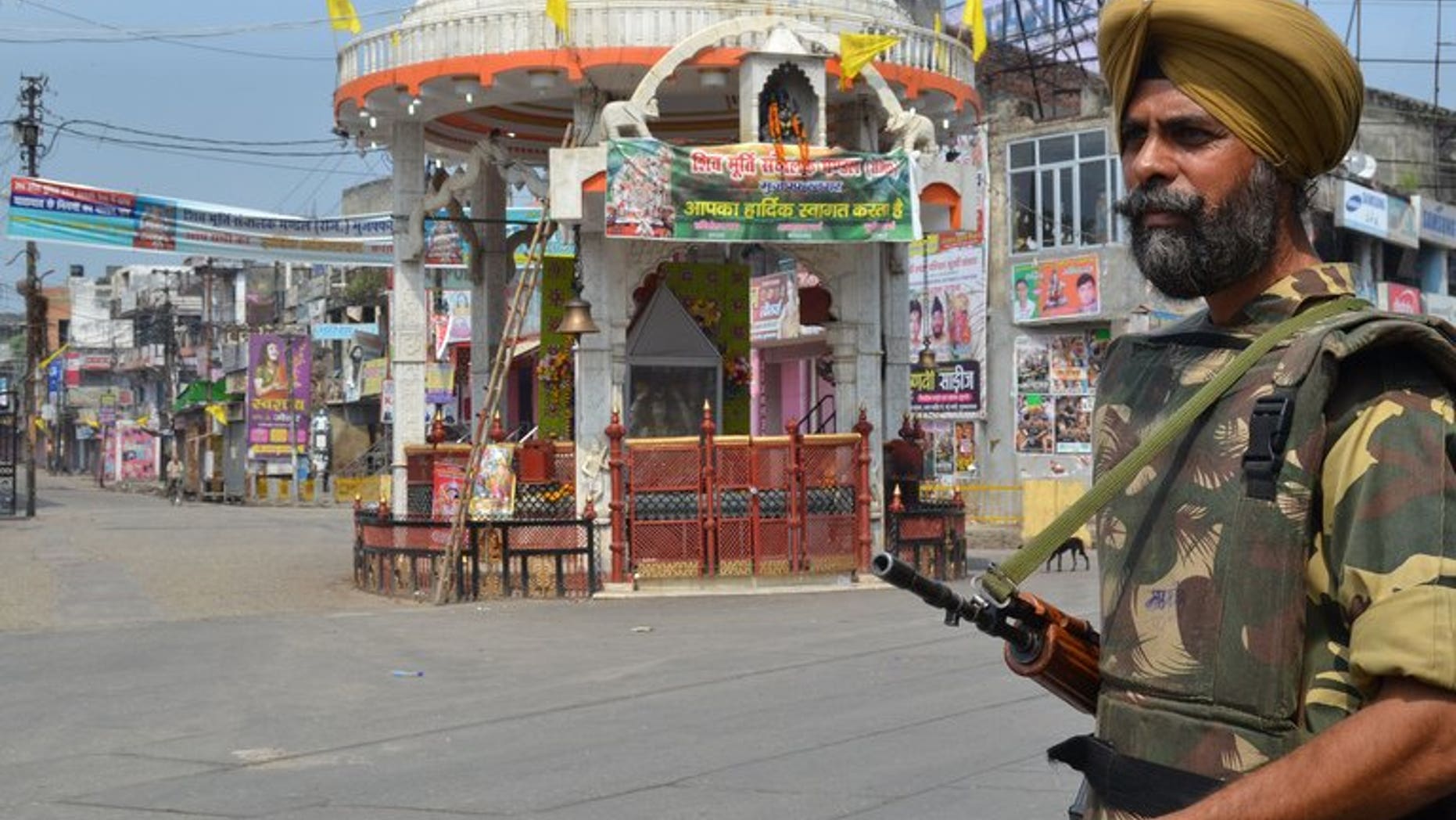 An Indian soldier keeps watch on a deserted street following communal riots between Muslims and Hindus in Muzaffarnagar, India's Uttar Pradesh state, on September 9, 2013. The death toll from Hindu-Muslim clashes in India's most populous state Uttar Pradesh has climbed to 31, police said Tuesday, but the violence has been brought under control.