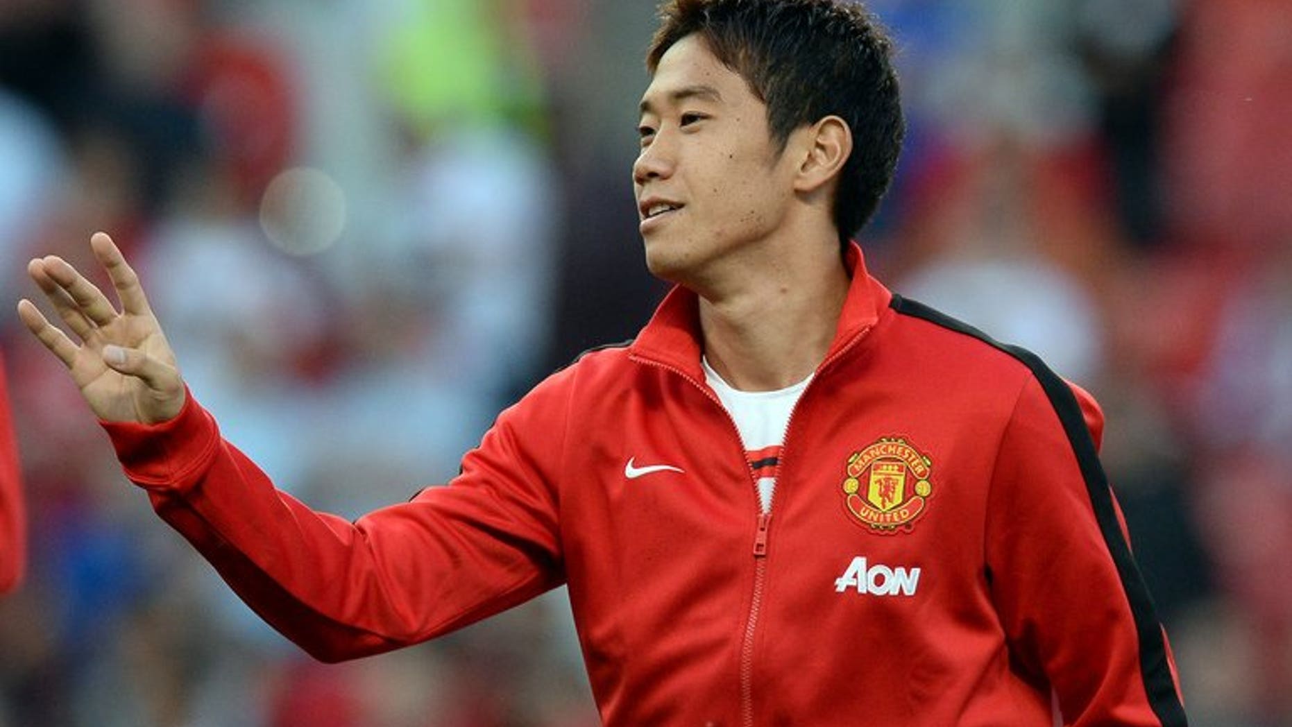 Shinji Kagawa warms up ahead of Manchester United's game against Chelsea at Old Trafford on August 26. Kagawa voiced frustration at being sidelined by new Manchester United manager David Moyes after scoring a cracker in his country's 3-1 win over Ghana on Tuesday.