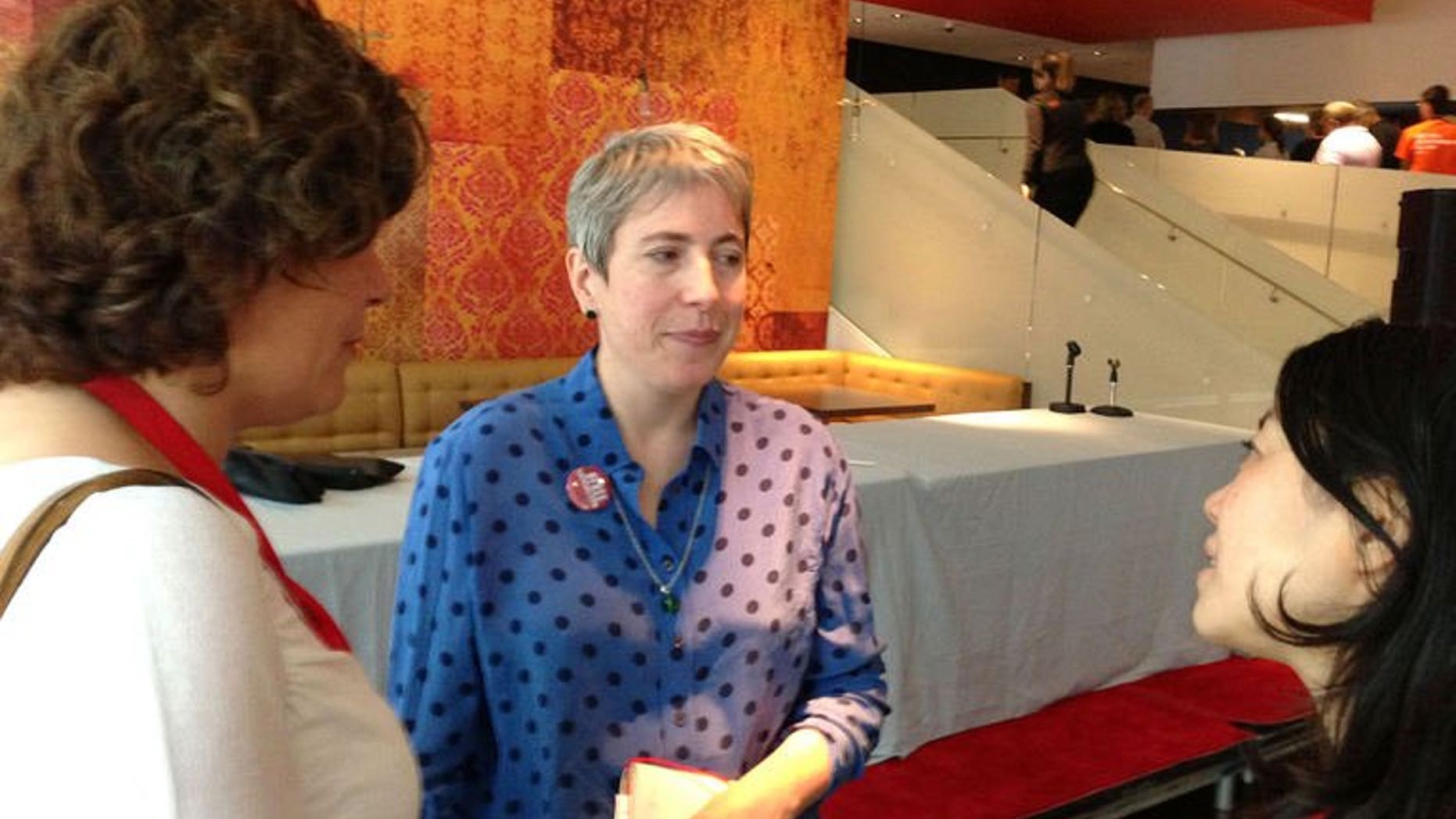 Cecilia Greyson (C) speaks to supporters after a press conference September 10, 2013, on the sidelines of the Toronto Film Festival in Canada.