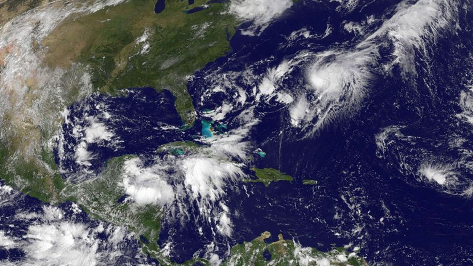This NASA satellite image, released September 2013, shows Tropical Storm Gabrielle (Upper R) closing in on Bermuda. Forecasters said the storm, which was some 120 miles south of the island, was strengthening and approaching.