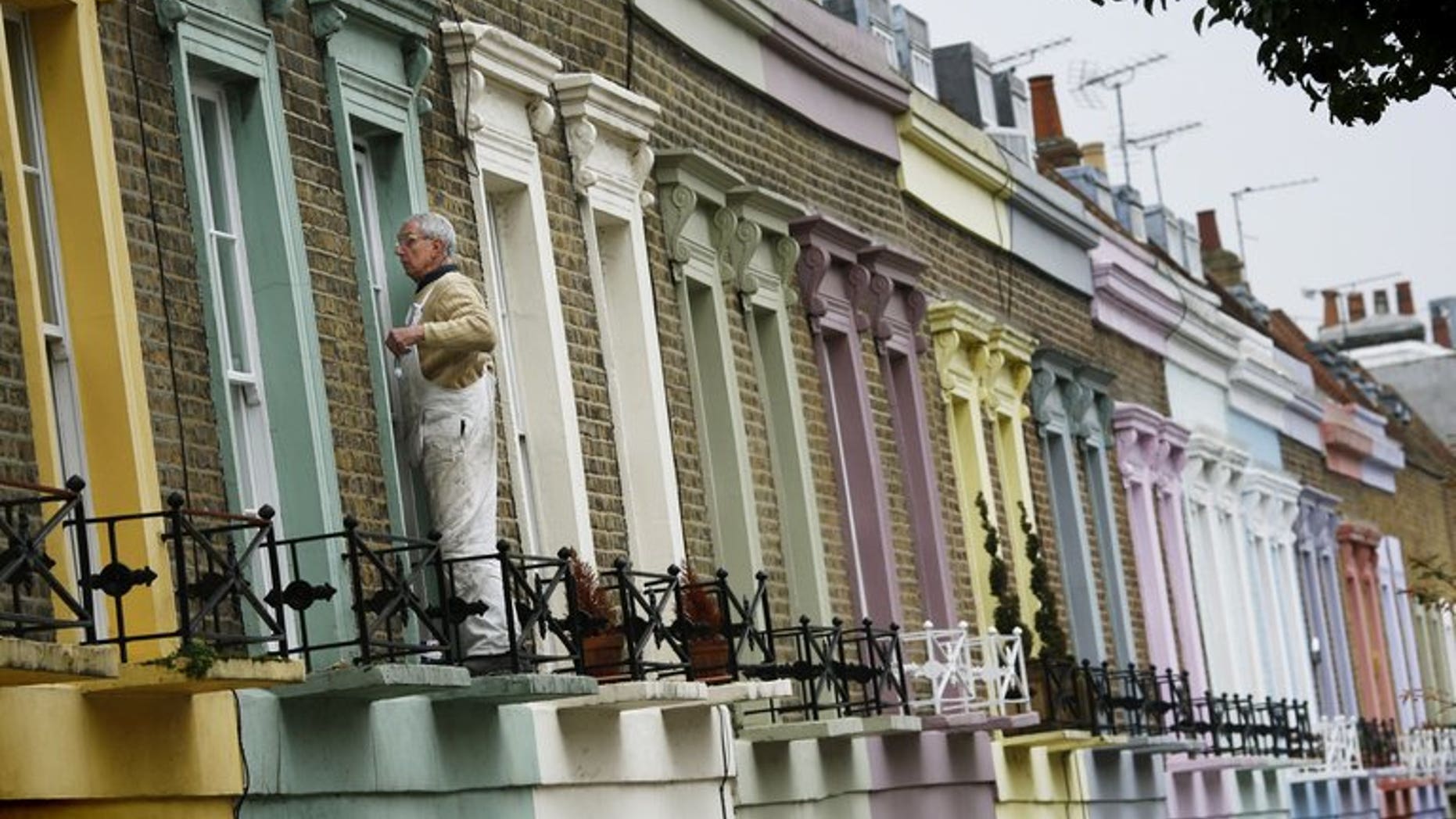A decorator paints a window frame on a house in Camden in London, on November 3, 2008. The United Nations' special rapporteur on housing called for Britain to scrap its so-called "bedroom tax" because of its "shocking" impact on the poor and vulnerable, sparking an angry response from the government.