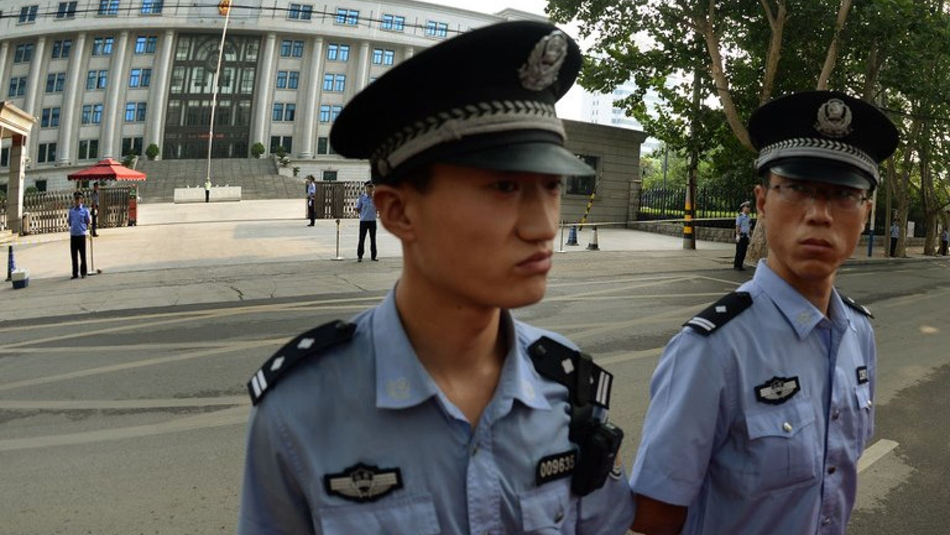 Illustration: Police outside a court in Beijing, where disgraced politician Bo Xilai was tried for graft