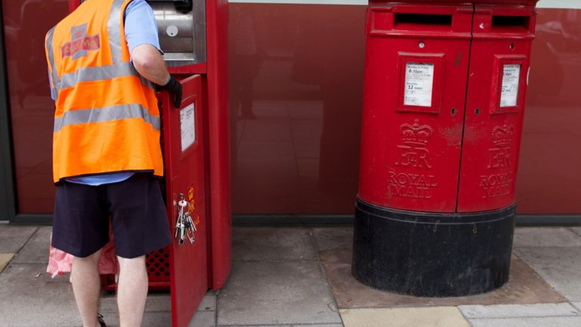 A postman empties a Royal Mail post box in London on July 10, 2013. Part sale of Royal Mail could be worth up to ??3.0 billion ($4.74 billion, 3.57 billion euros), reports say. The government previously said that it would take on Royal Mail's historic pension deficit.
