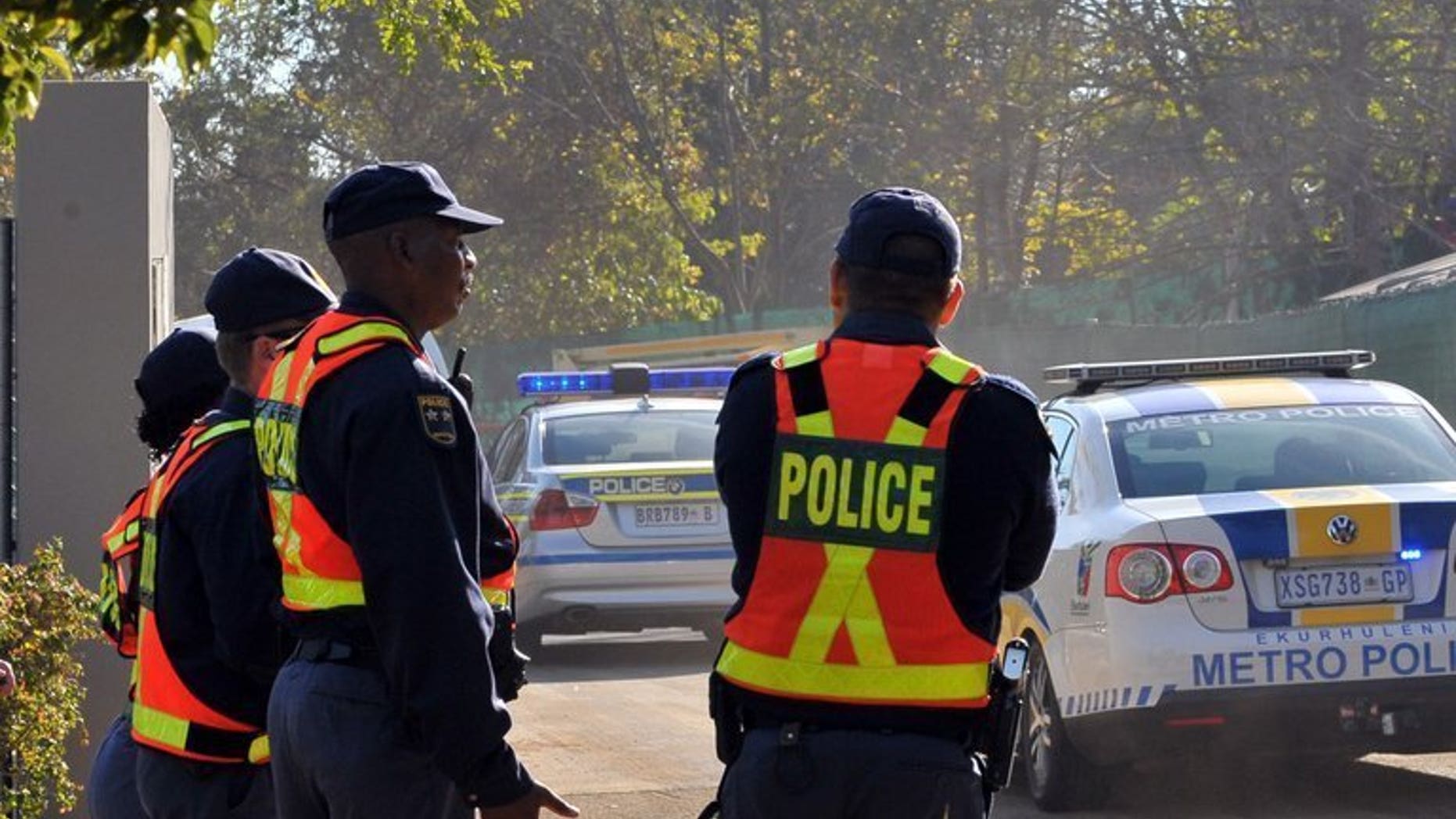 File picture shows police standing guard in Johannesburg on May 27, 2010. South African police arrested a housekeeper after a break-in at the upmarket Johannesburg home of controversial Indian moguls closely linked to President Jacob Zuma.