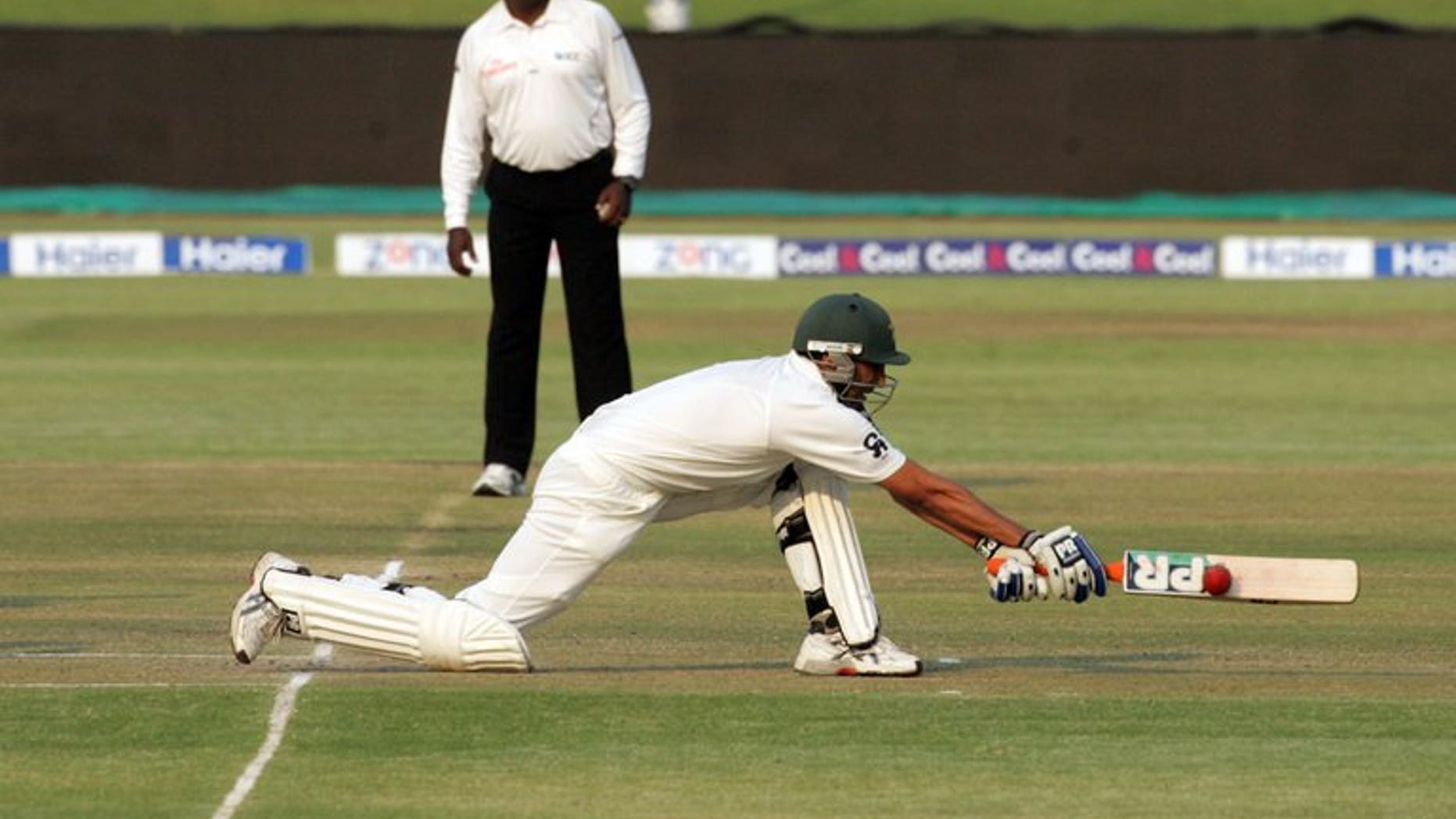 Pakistan batsman Younis Khan executes a reverse sweep shot during the second day of the second test match between Pakistan and hosts Zimbabwe at the Harare Sports Club on September 11, 2013. Pakistan were 211 for five at lunch, still 83 runs behind Zimbabwe's first innings total of 294, with Younis unbeaten on 76.