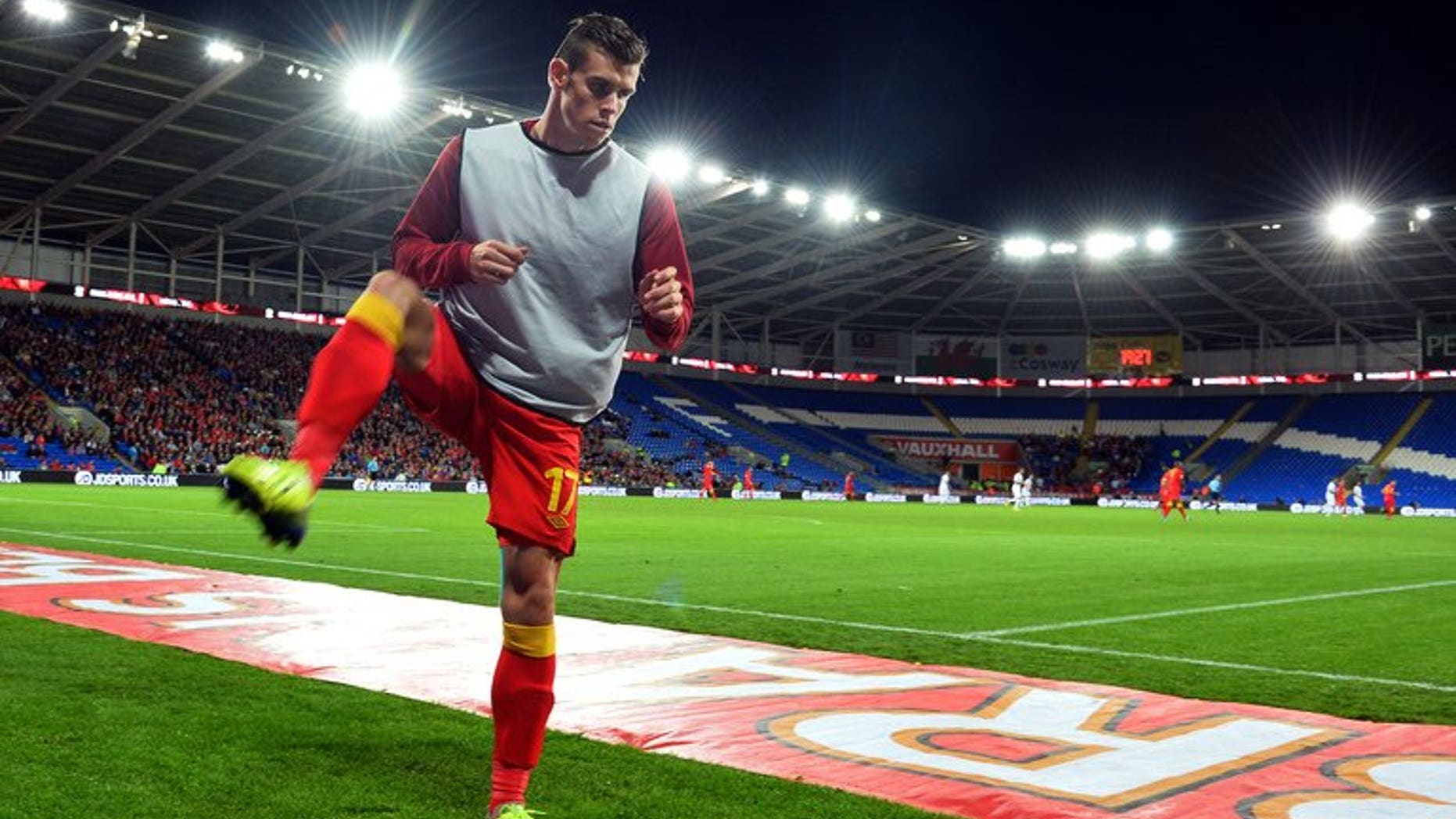 Wales midfielder Gareth Bale warms up during the World Cup 2014 European Zone group A qualifying football match between Wales and Serbia at Cardiff City Stadium on September 10, 2013. Gareth Bale said on Thursday he was "a bit behind" his new Real Madrid team-mates in terms of fitness, after a close season hampered by injury.