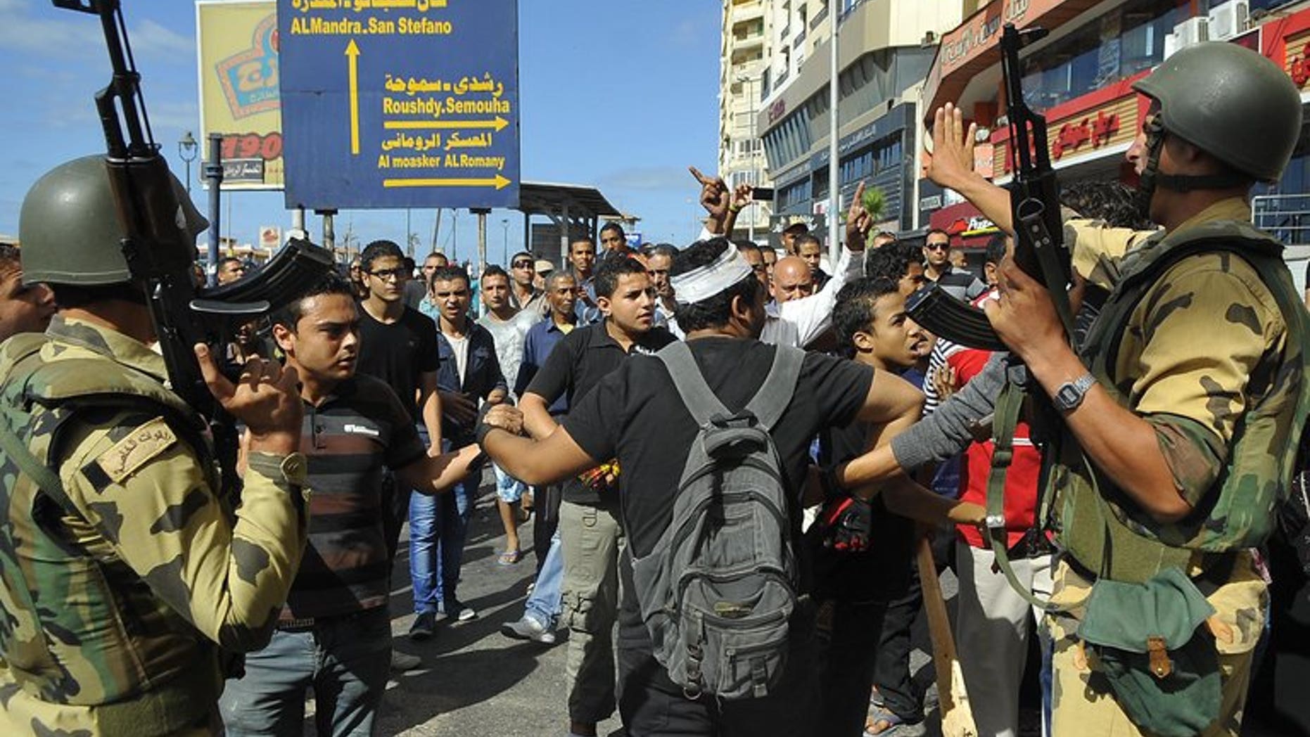 Egyptian soldiers patrol as supporters of the Muslim Brotherhood and Egypt's ousted president Mohamed Morsi clash with opposition demonstrators in Alexandria on September 6, 2013. Interim president Adly Mansour on Thursday extended by two months Egypt's state of emergency in force since mid-August, his spokesman said.