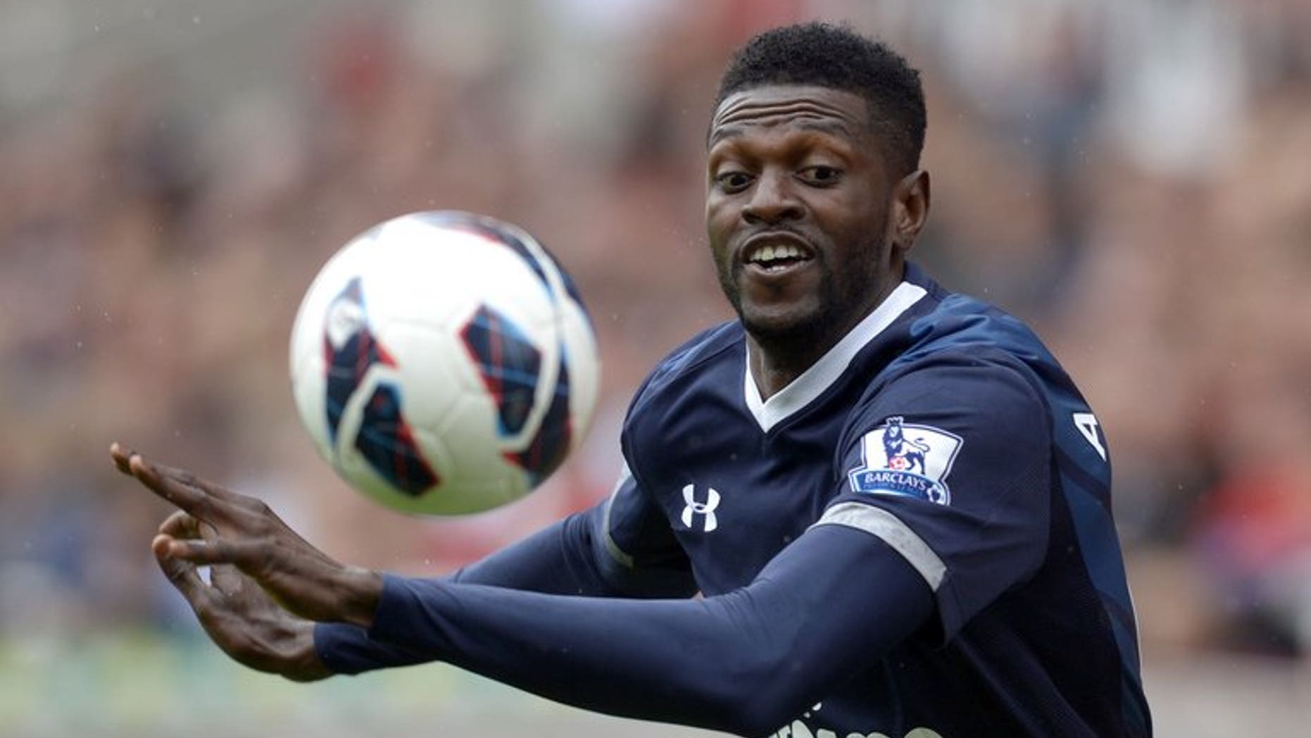 Tottenham Hotspur's Togolese striker Emmanuel Adebayor eyes the ball during the Premier League match against Stoke City in Stoke on Trent, central England, on May 12, 2013. Tottenham Hotspur manager Andre Villas-Boas revealed on Thursday that he has asked Togolese striker Emmanuel Adebayor to train with the Premier League club's reserve team.