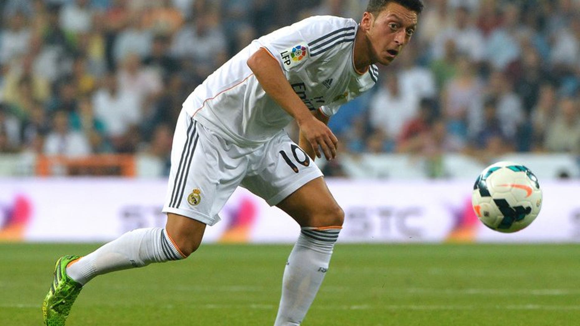Then-Real Madrid midfielder Mesut Ozil eyes the ball during their Spanish league match against Real Betis in Madrid on August 18, 2013. Record Arsenal signing Mesut Ozil said on Thursday that he believes the club can challenge for the English Premier League title this season.