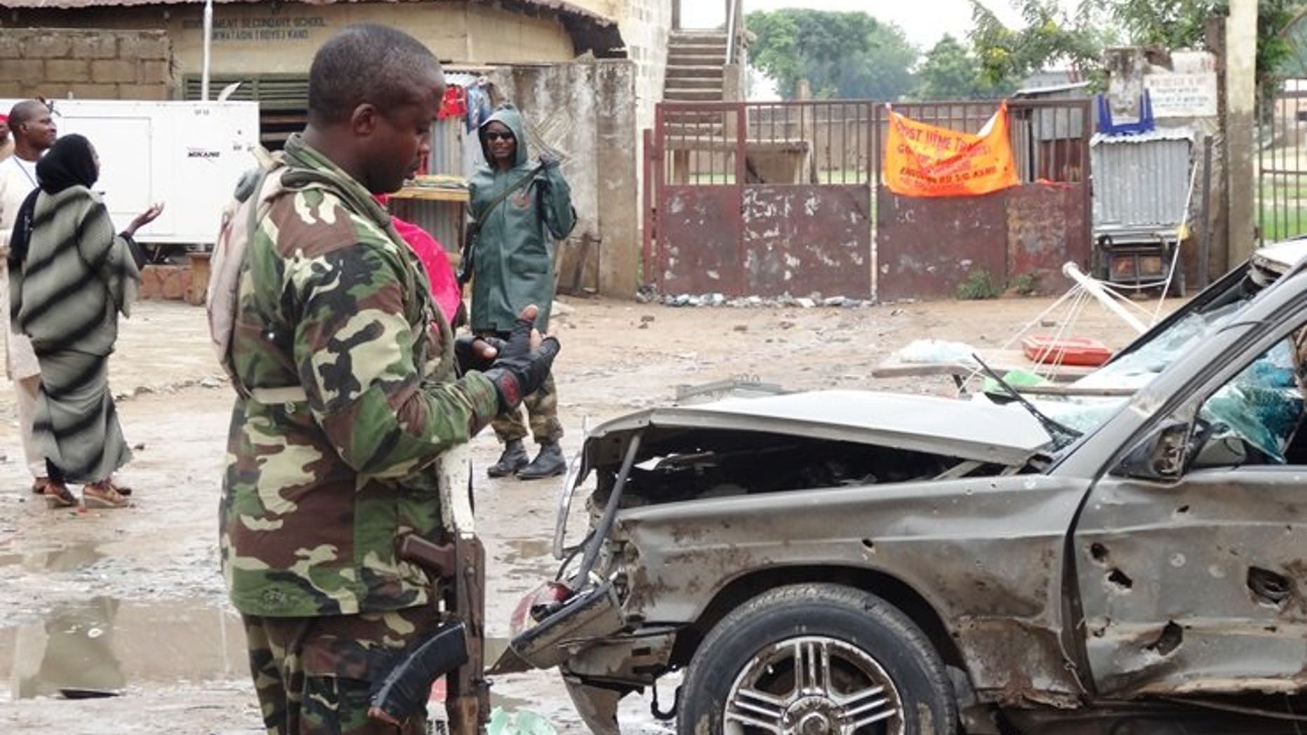 A soldier stands at the scene of an explosion in the downtown Sabon Gari neighbourhood of Kano on July 30, 2013.