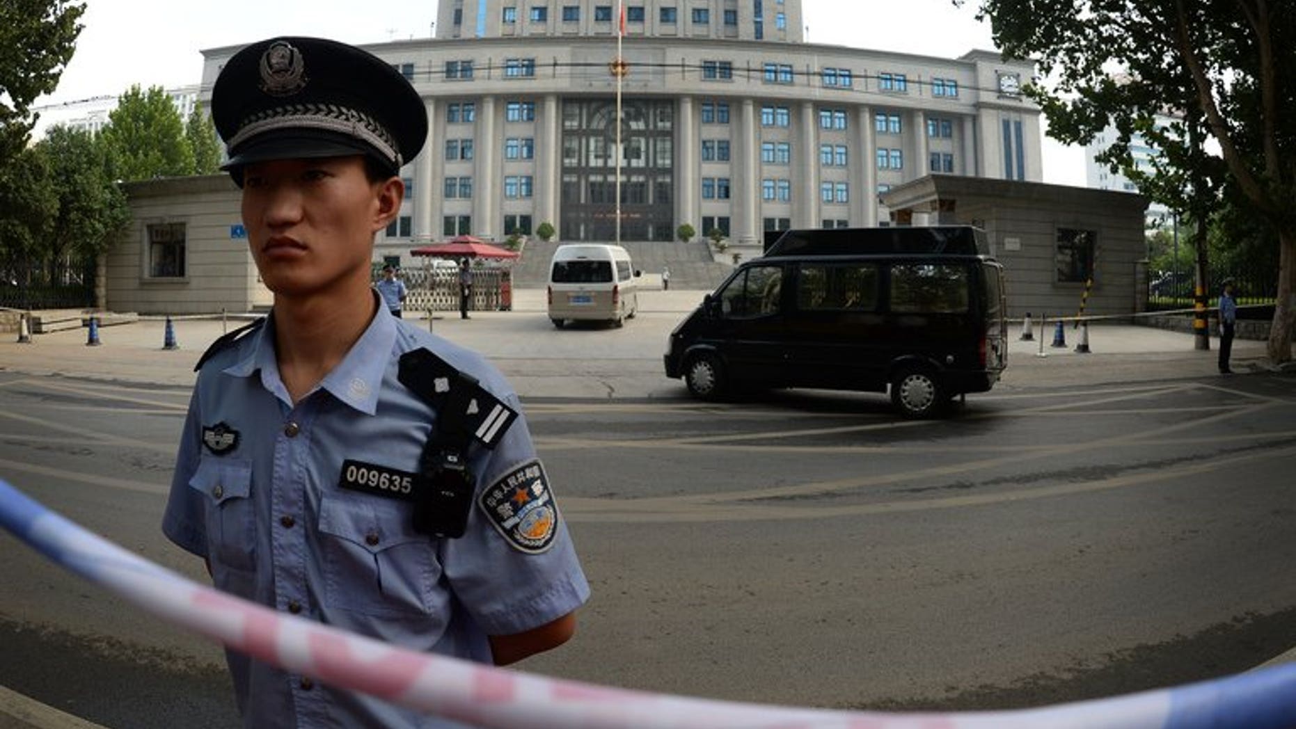 Police stand guard outside the Intermediate People's Court in Jinan, Shandong Province on August 25, 2013. Police on Friday detained an outspoken Chinese businessman who had called for the release of a prominent lawyer arrested as part of a crackdown on anti-corruption activists, a friend told AFP.