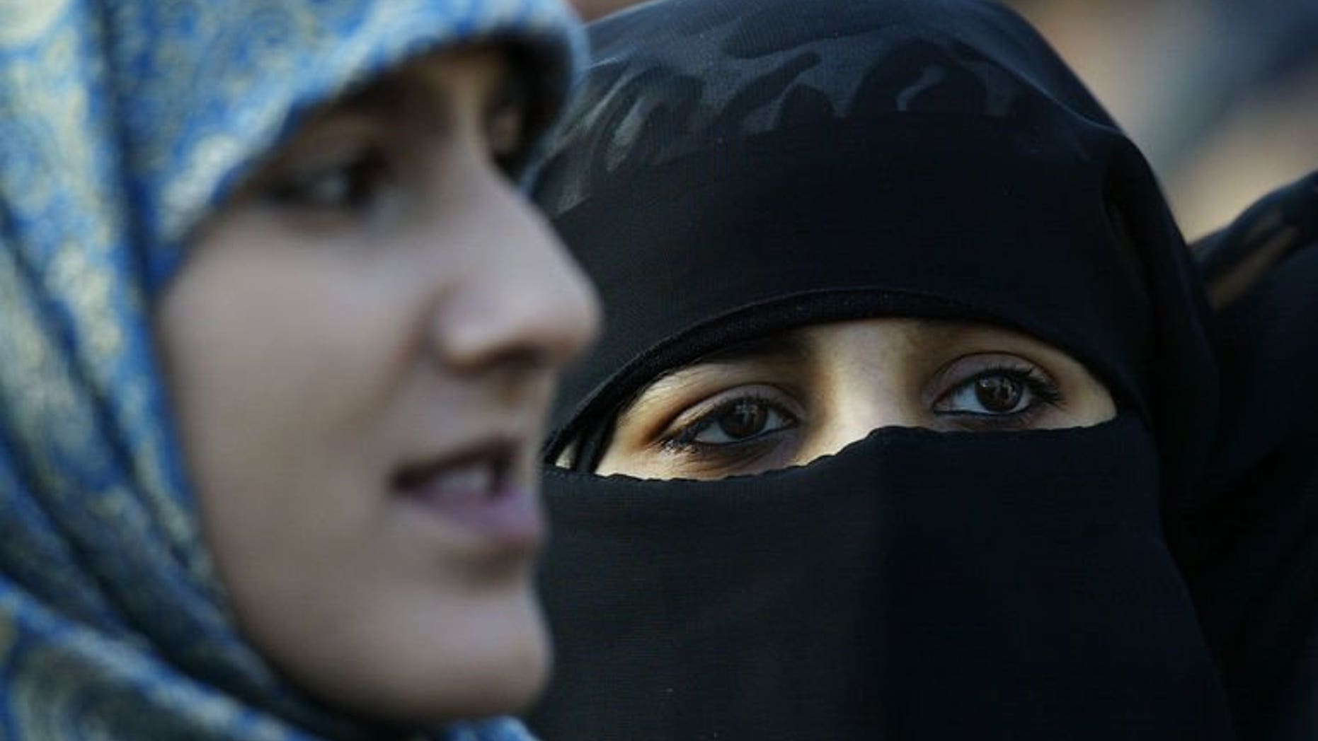 Veiled Muslim women stand at Marble Arch in London during a protest against French headscarf bans on January 17, 2004. One of Britain's biggest colleges on Friday dropped a ban on Muslim face veils after thousands of people signed a petition against the rule.