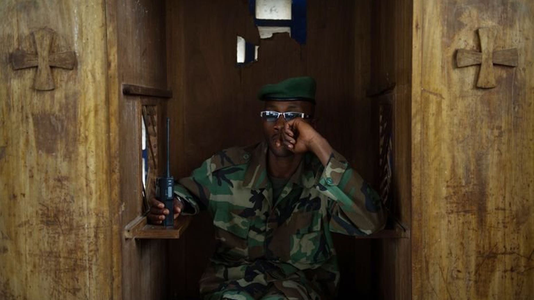 An M23 soldier sits in a confession booth in a church during a session to teach the rebel movement's values in Rumangabo in the east of the Democratic Republic of Congo, on July 20, 2013. Mediators in peace talks between Democratic Republic of Congo's government and M23 rebels admitted Friday the sides were yet to negotiate face-to-face, but insisted that progress was still being made.