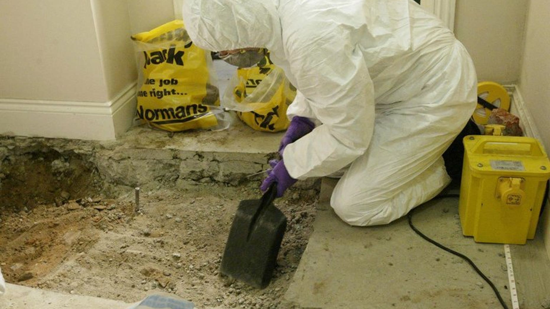 File picture for illustration only shows a forensic officer at a crime scene. Police investigating a murder in Leicester have arrested a man and two women and are looking into possible links with a fire which killed a mother and her three children.