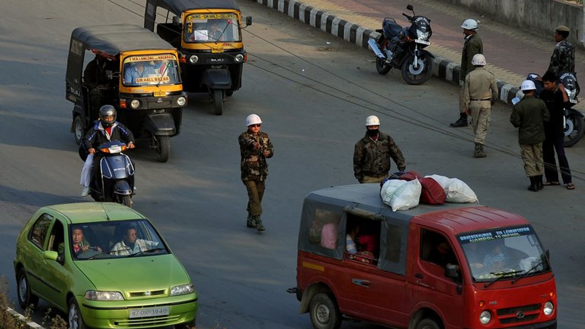 File picture shows a police checkpoint in Imphal in the northeastern Indian state of Manipur. A powerful bomb blast in a busy area on the outskirts of Imphal has killed nine labourers and injured about 21 other people, police said Saturday.