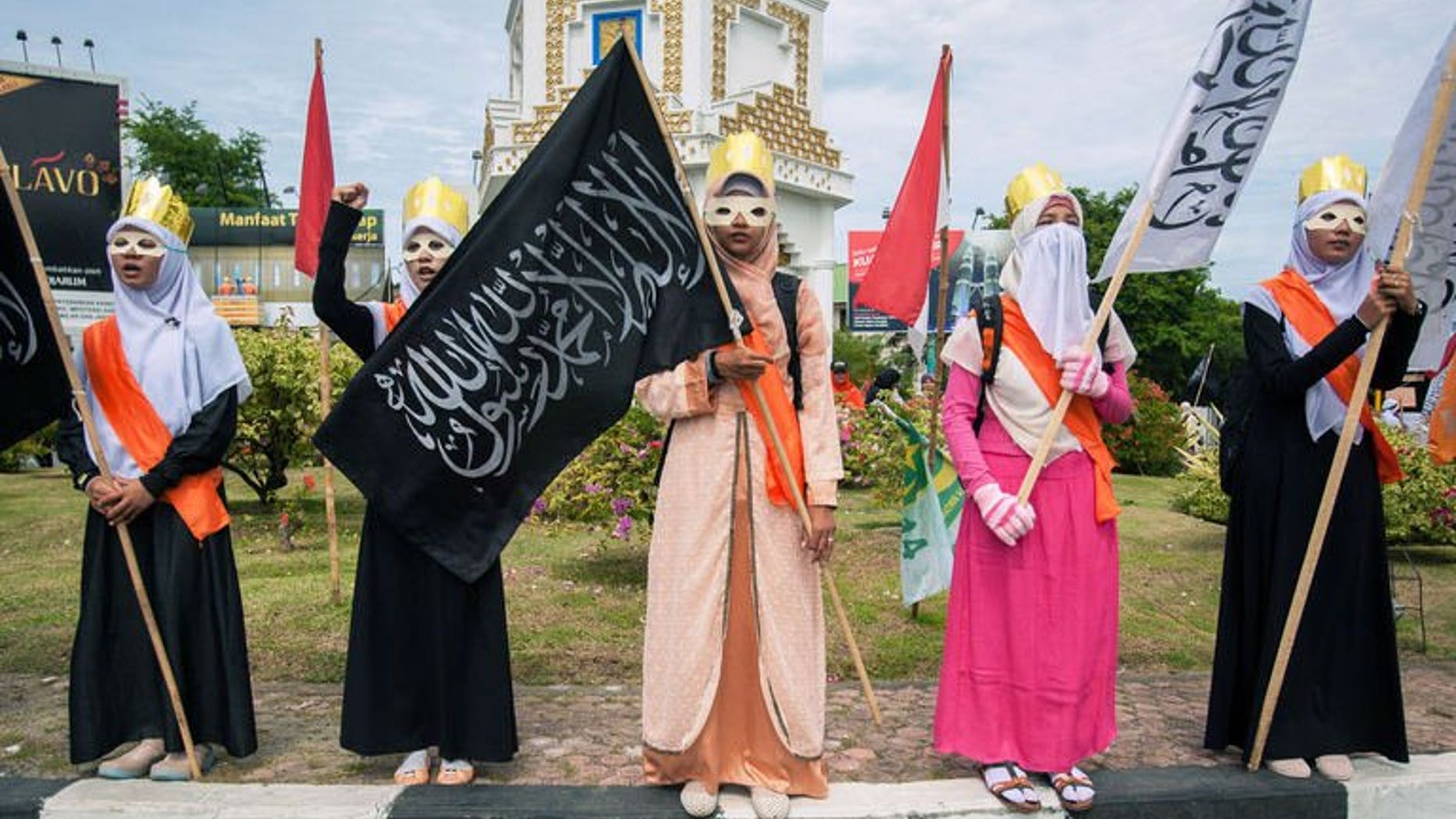 Muslim women stage a protest against the Miss World beauty pageant contest in Banda Aceh, northern Sumatra island, on September 14, 2013. The Miss World beauty contest, which has attracted fierce opposition by hardline Islamic groups in Indonesia, is now facing another challenge -- a rival pageant exclusively for Muslims.
