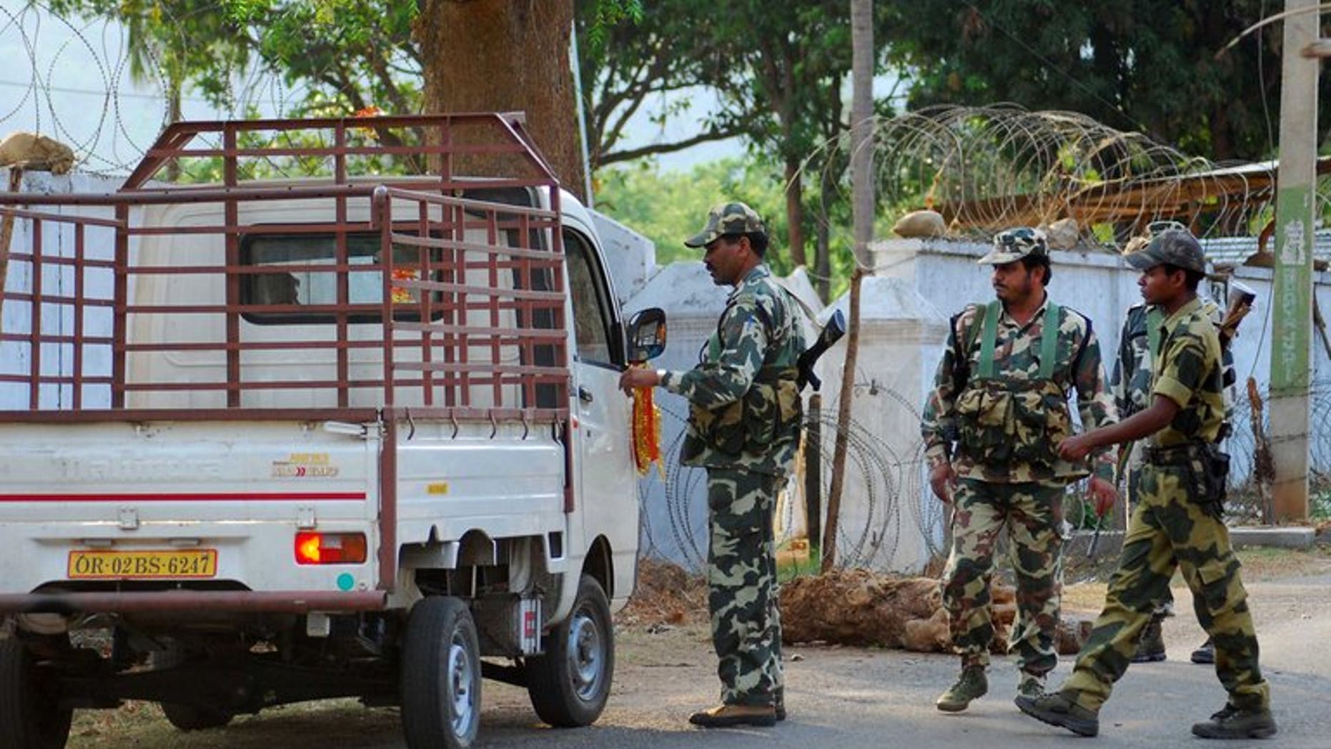 Indian Central Reserve Police Force soldiers inspect a vehicle on a road in the eastern Indian state of Orissa, some 220 kms south-west of Bhubaneswar, on April 6, 2012. Security forces killed 14 Maoists in a firefight in eastern India on Saturday, police said, marking the latest bloodshed in a long conflict in which the rebels have been battling to overthrow the government.