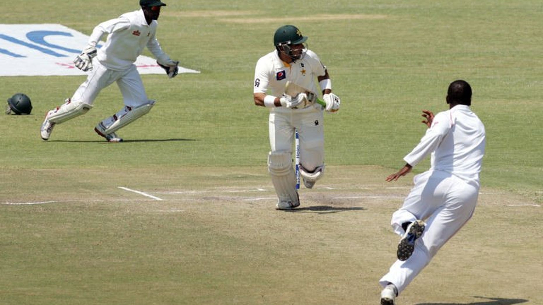Pakistan's captain Misbah-Ul-Haq (centre) runs during the second Test match against Zimbabwe in Harare on September 14, 2013. Misbah hit his third half-century of the series, but his team lost three wickets on a tense fifth day of the second Test.
