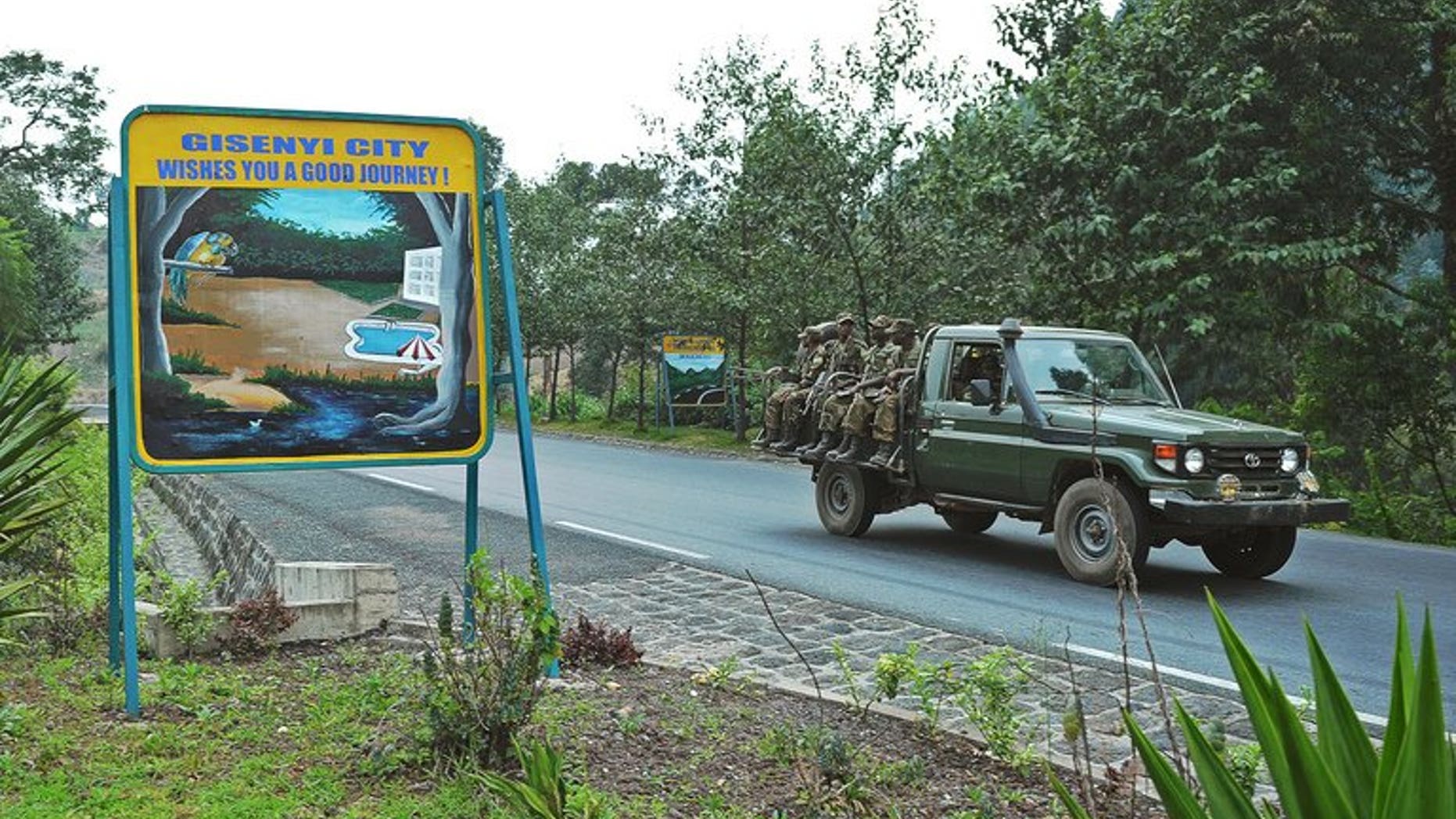 Rwandan soldiers pass a sign welcoming drivers to the city of Gisenyi, on the border with the Democratic Republic of Congo on August 30, 2013. Southern African nations have expressed concern at the growing number of Rwandan troops on the border of the Democratic Republic of Congo and said it hoped an invasion was not imminent.