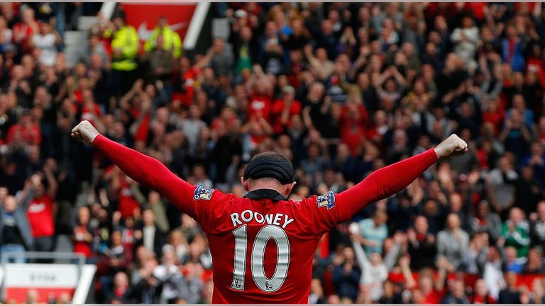 Manchester United striker Wayne Rooney celebrates after scoring his team's second goal from a free kick during the English Premier League match against Crystal Palace in Manchester on September 14, 2013. Rooney returned from injury to give manager David Moyes his first win at Old Trafford as the striker's free-kick clinched a 2-0 victory.