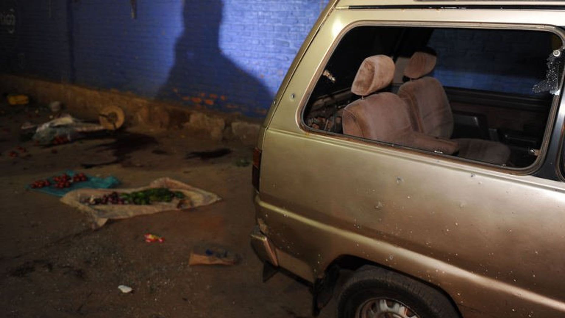 A damaged vehicle at the scene of a grenade attack in Kigali, Rwanda on September 13. One person was killed in the attack.
