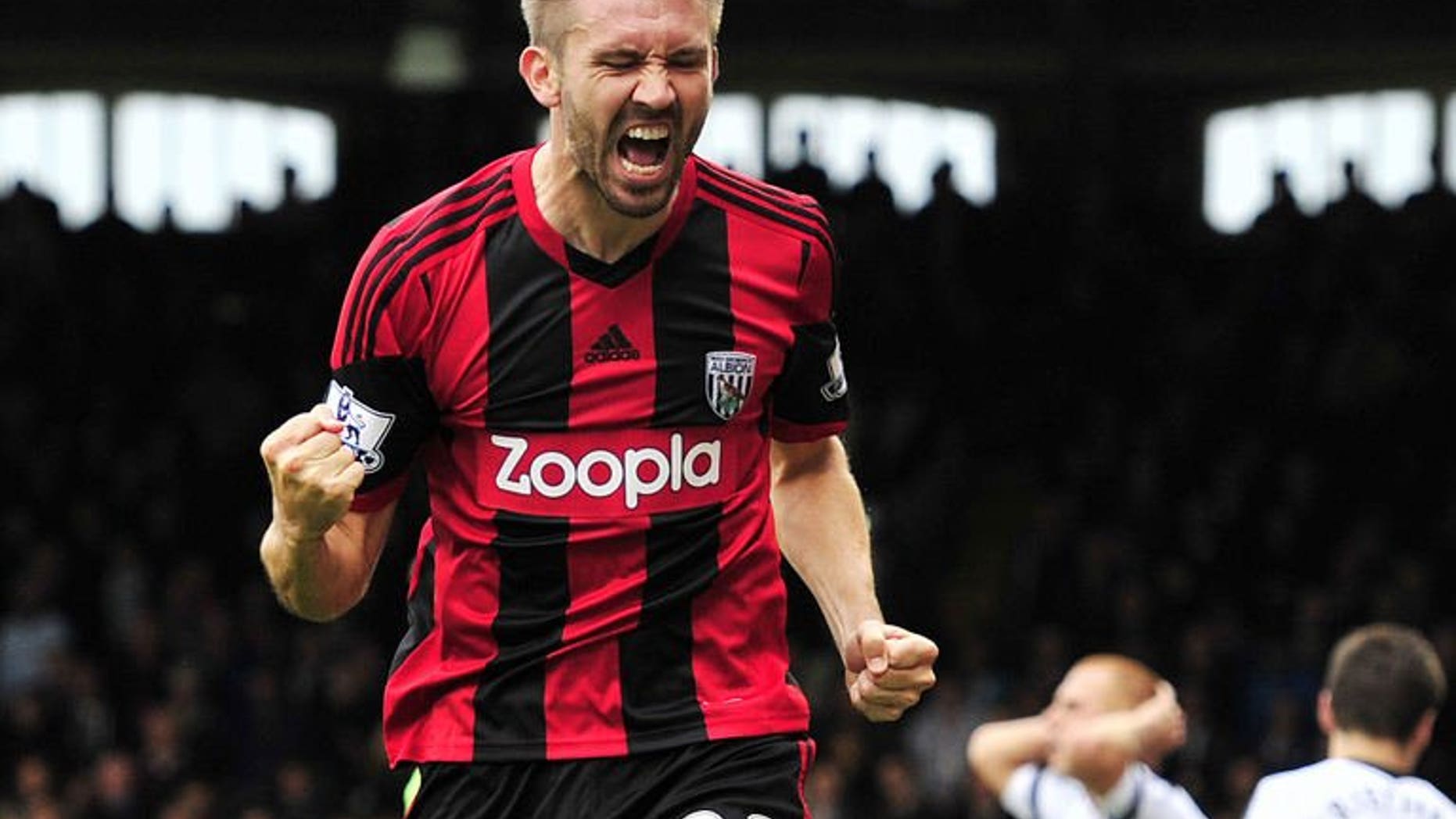 West Bromwich Albion's Northern Irish defender Gareth McAuley celebrates scoring the equalising goal during the English Premier League football match between Fulham and West Bromwich Albion at Craven Cottage in London on September 14, 2013. The match ended in a 1-1 draw.