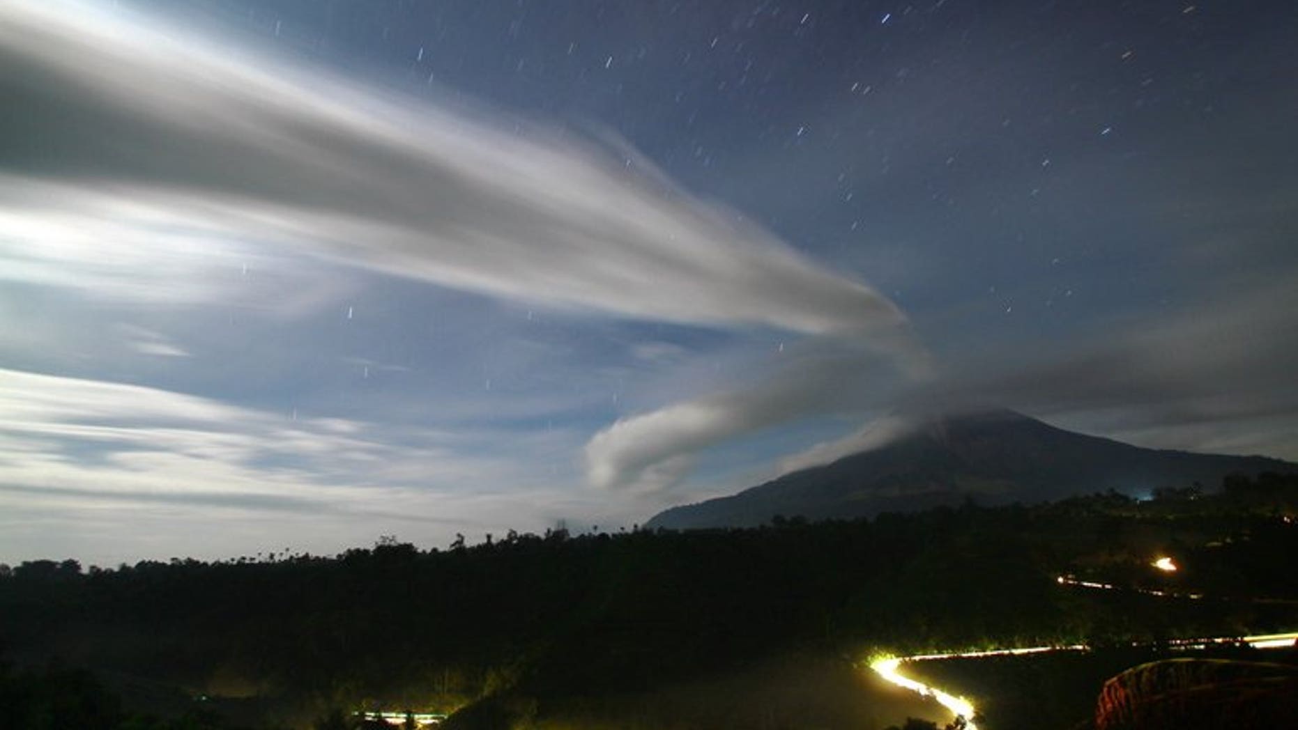File picture shows plume of volcanic ash being emitted by Mount Sinabung in Tanah Karo district in North Sumatra province, seen under moon light from in this time exposure taken late September 16, 2010.