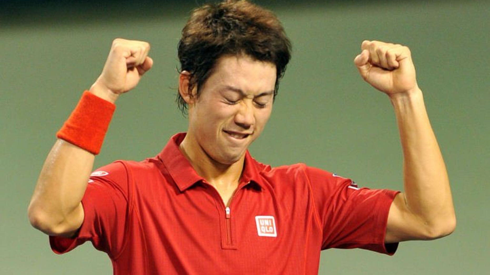 Japan's Kei Nishikori celebrates his win over Santiago Giraldo of Colombia after their Davis Cup World Group play-off in Tokyo on September 15, 2013. Nishikori beat Giraldo 6-1, 6-2, 6-4, propelling Japan back into the Davis Cup world group.