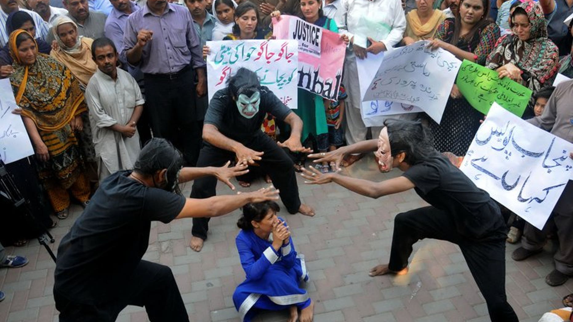 Pakistani workers from NGOs perform during an anti-rape protest in Lahore on September 14, 2013.
