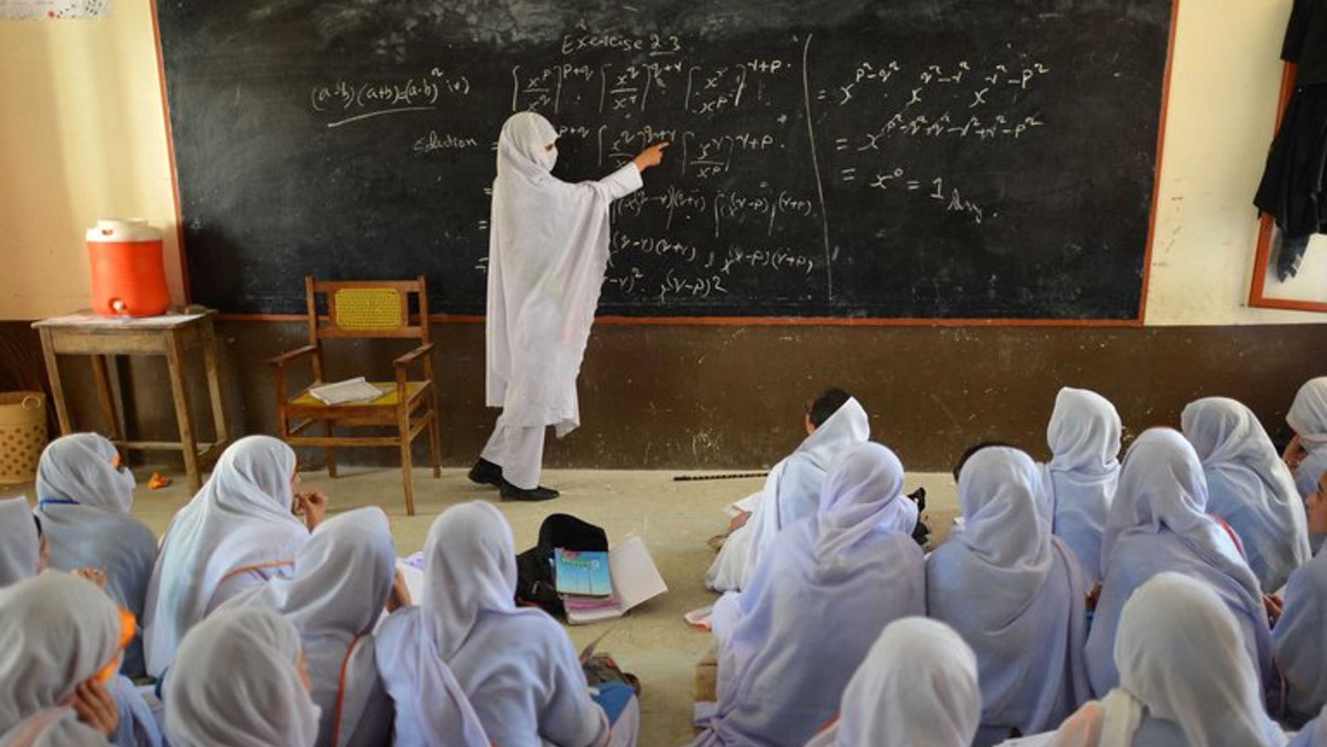 This photograph taken on June 21, 2013 shows a Pakistani teacher leading a class of girls at a school in Mingora, the main town of Swat valley.