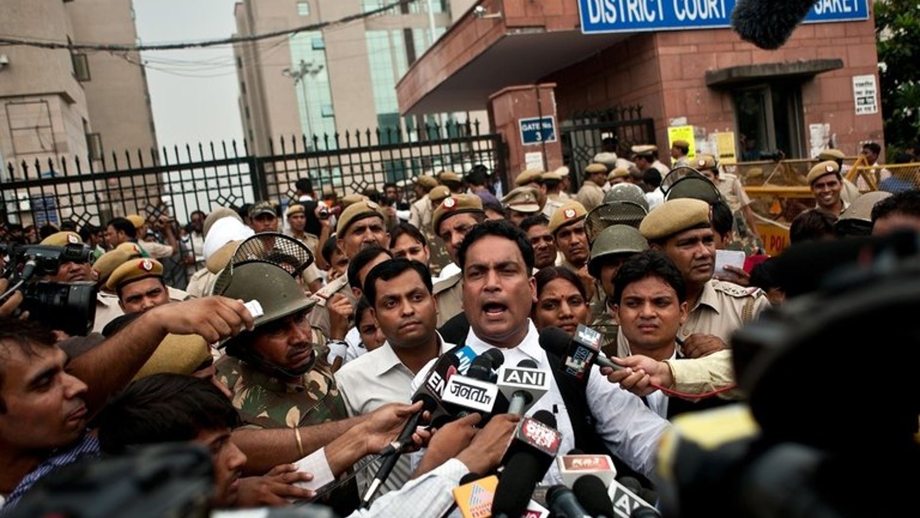 Indian defence lawyer A.P. Singh (C) addresses the media outside the Saket Court complex following the sentencing of four men convicted of rape and murder in New Delhi on September 13, 2013.