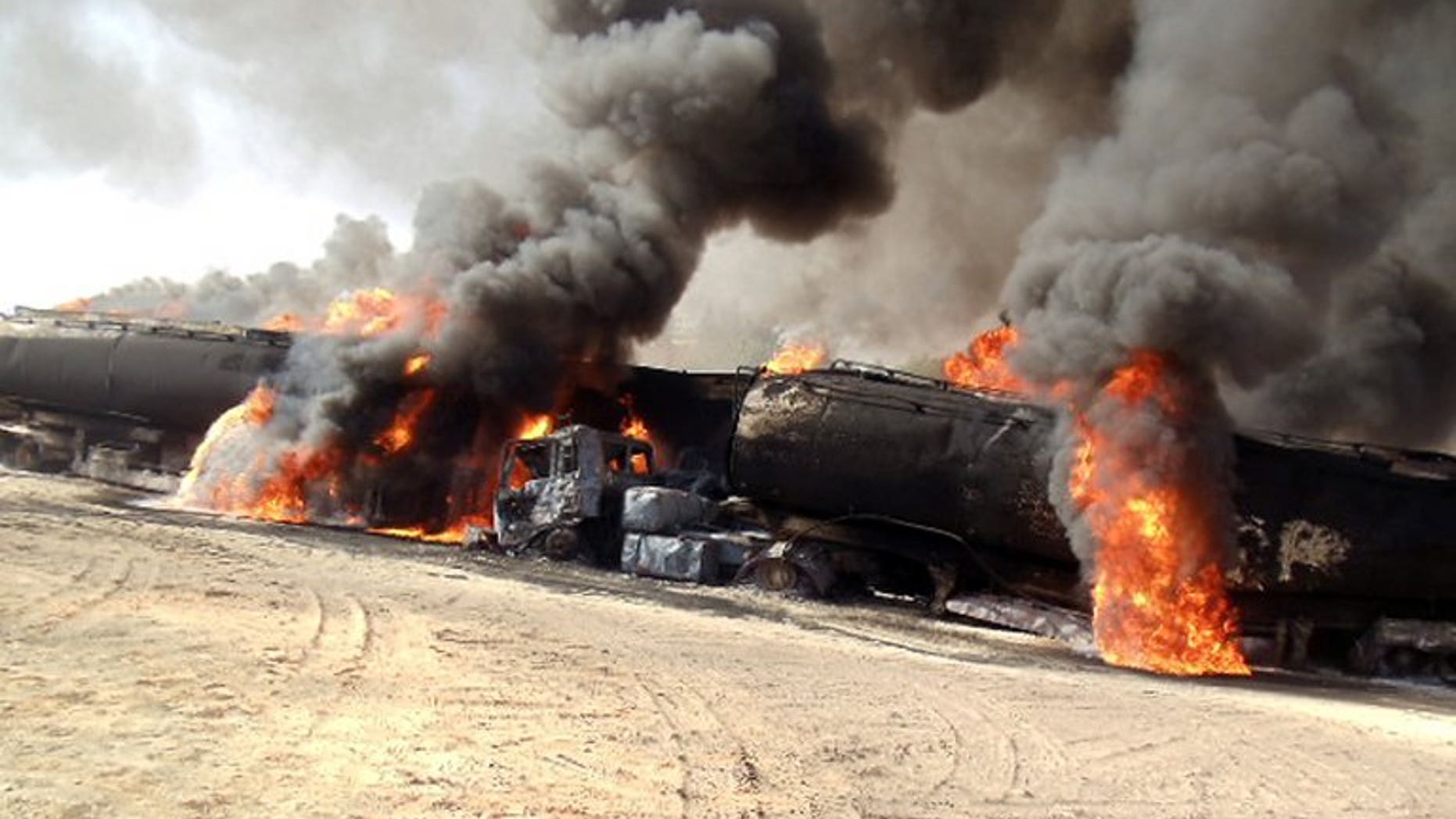 Smoke and flame rise from burning NATO supply oil tankers in Soorab town of Kallat district on September 13, 2013.